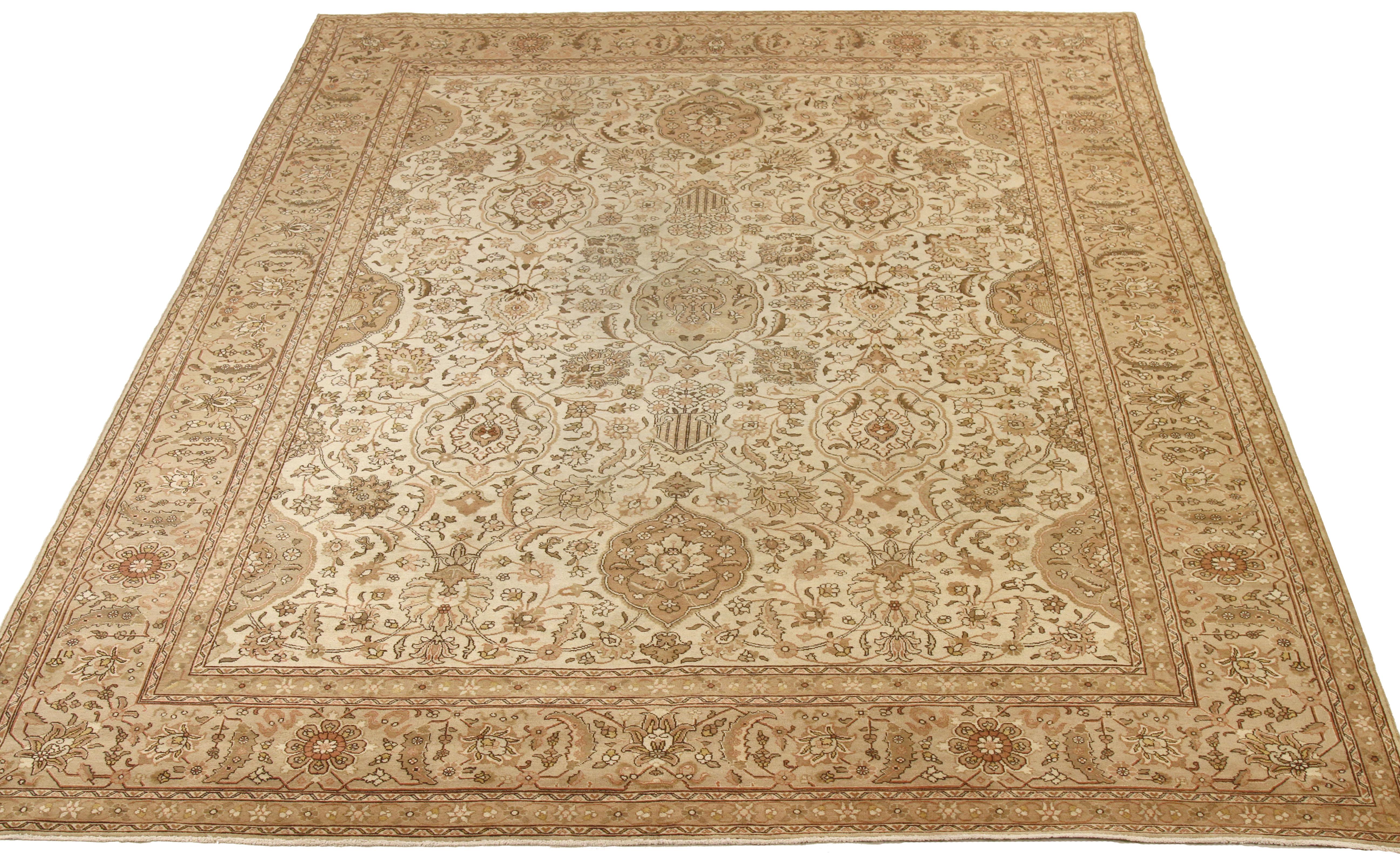 Antique mid-20th century hand-woven Persian area rug made from fine wool and all-natural vegetable dyes that are safe for people and pets. It features traditional Tabriz weaving depicting intricate botanical and animal patterns often in bold colors.