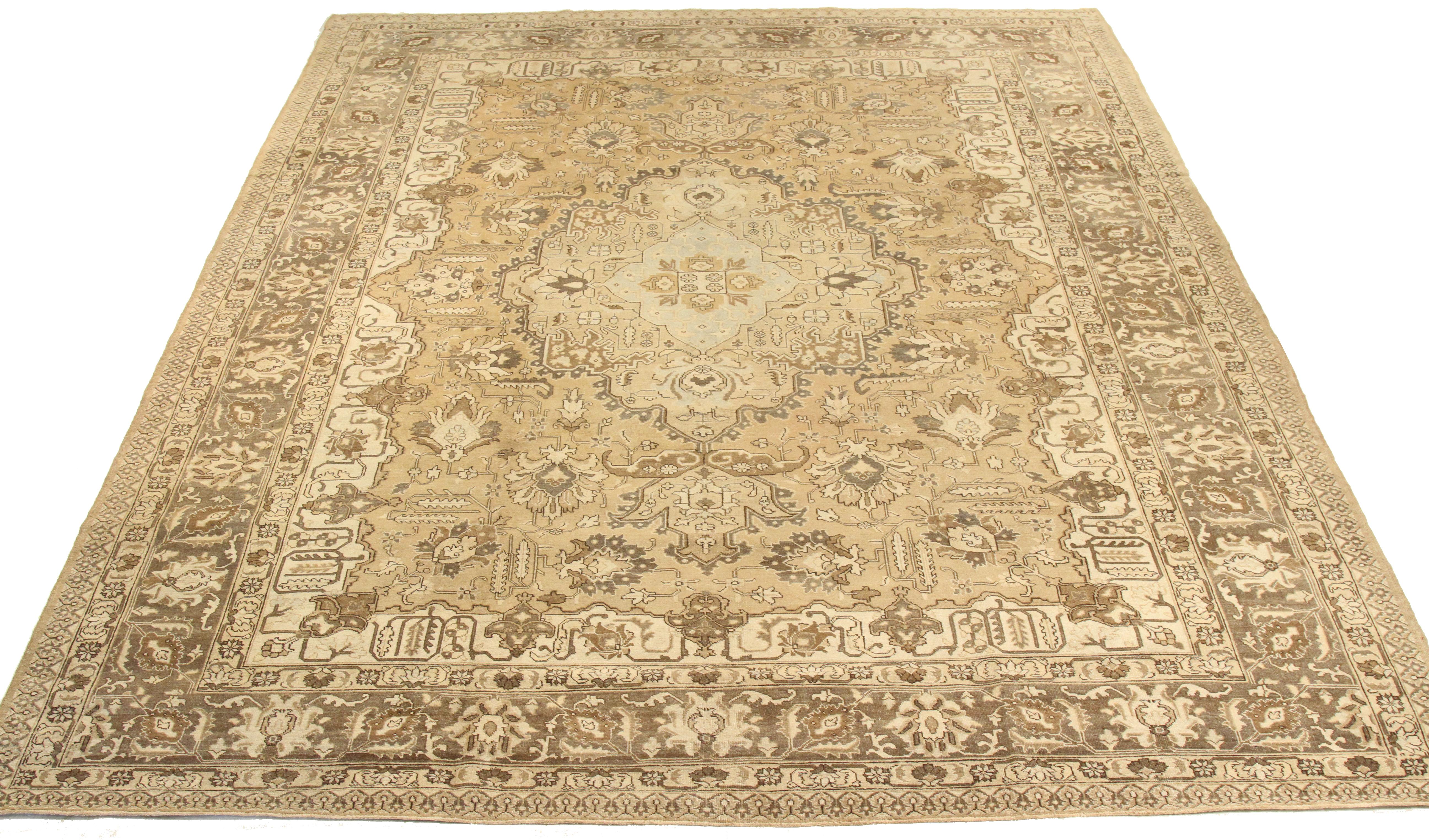 Antique mid-20th century hand-woven Persian area rug made from fine wool and all-natural vegetable dyes that are safe for people and pets. It features traditional Tabriz weaving depicting intricate botanical and animal patterns often in bold colors.