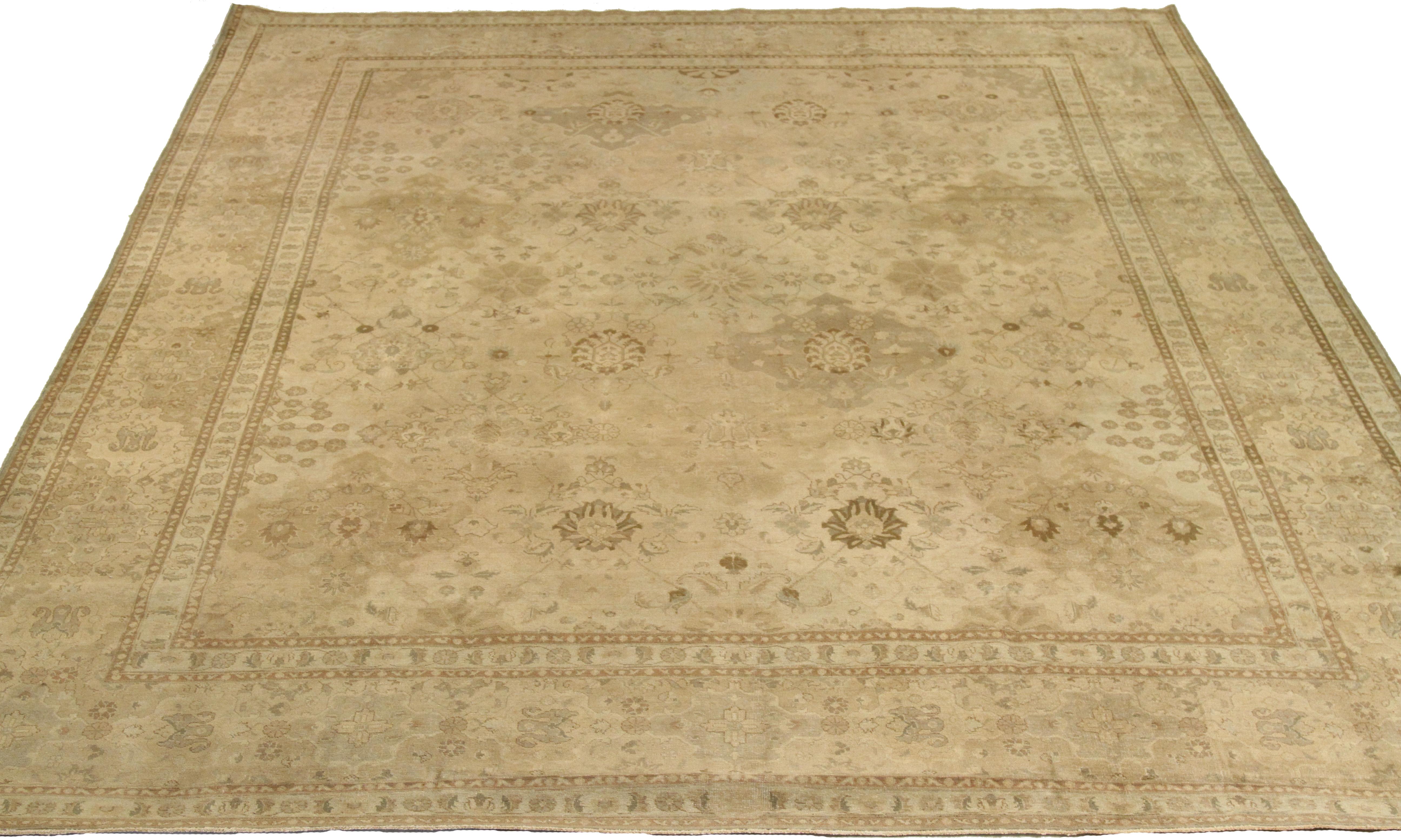 This antique mid-20th century hand-woven Persian area rug is a stunning piece made from fine wool and all-natural vegetable dyes that are safe for people and pets. The rug showcases traditional Tabriz weaving, featuring intricate botanical and