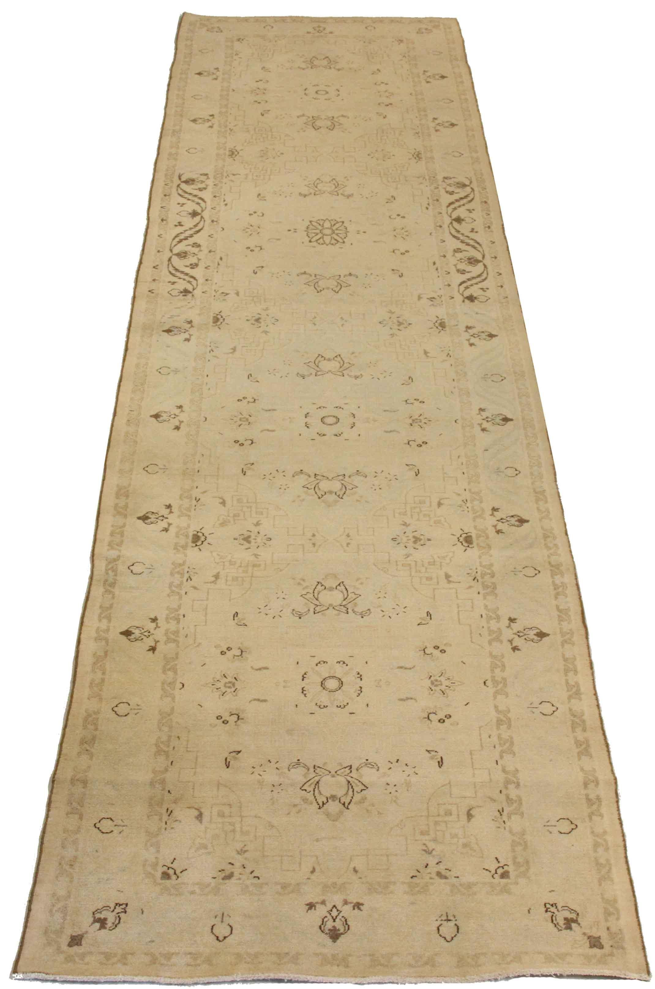 Antique mid-20th century hand-woven Persian runner rug made from fine wool and all-natural vegetable dyes that are safe for people and pets. It features traditional Tabriz weaving depicting intricate botanical and animal patterns often in bold