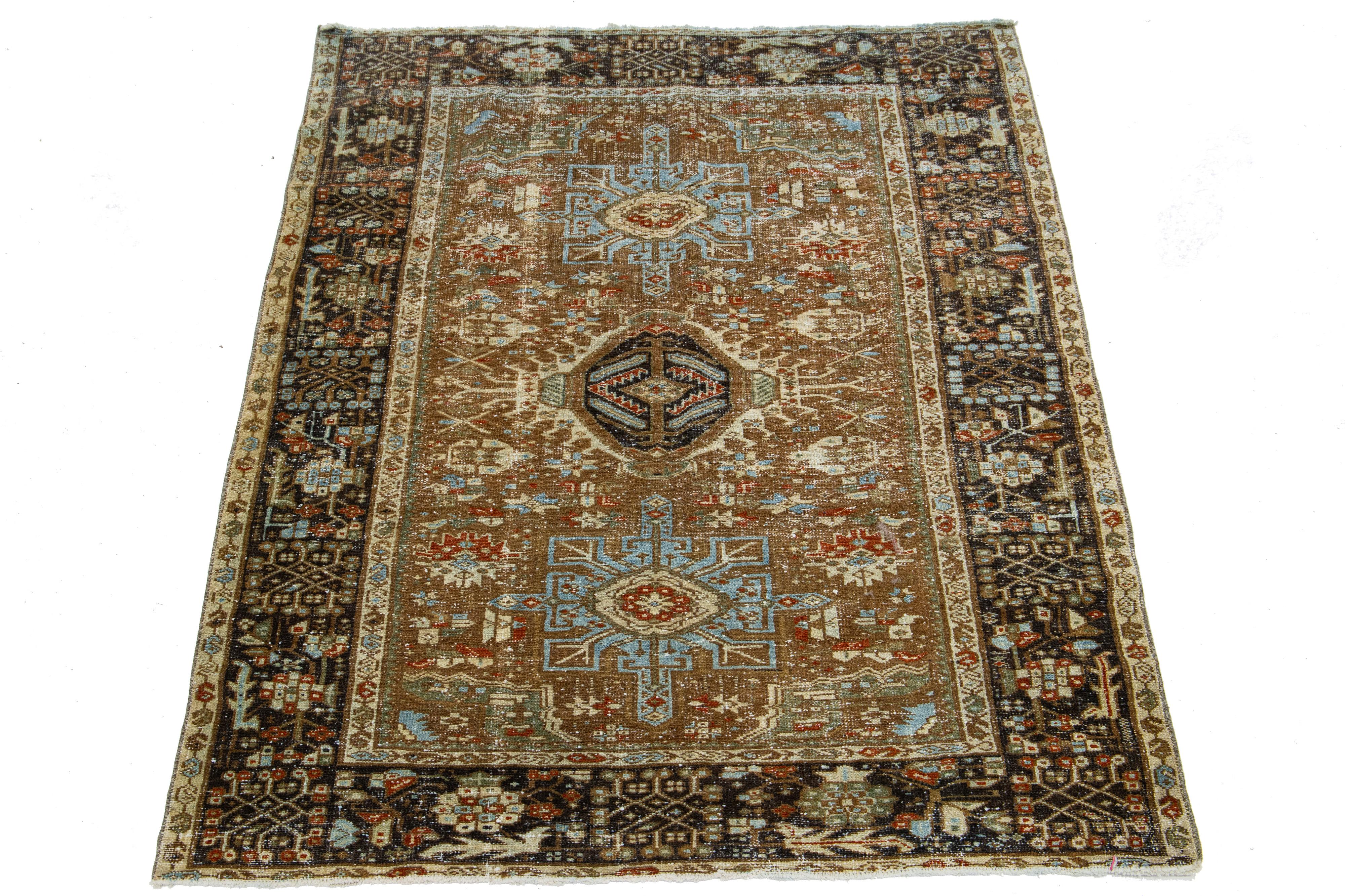 This Persian wool rug showcases an exquisite traditional floral medallion design with striking rust, beige, and blue accents against a brown background. 

This rug measures 4'6