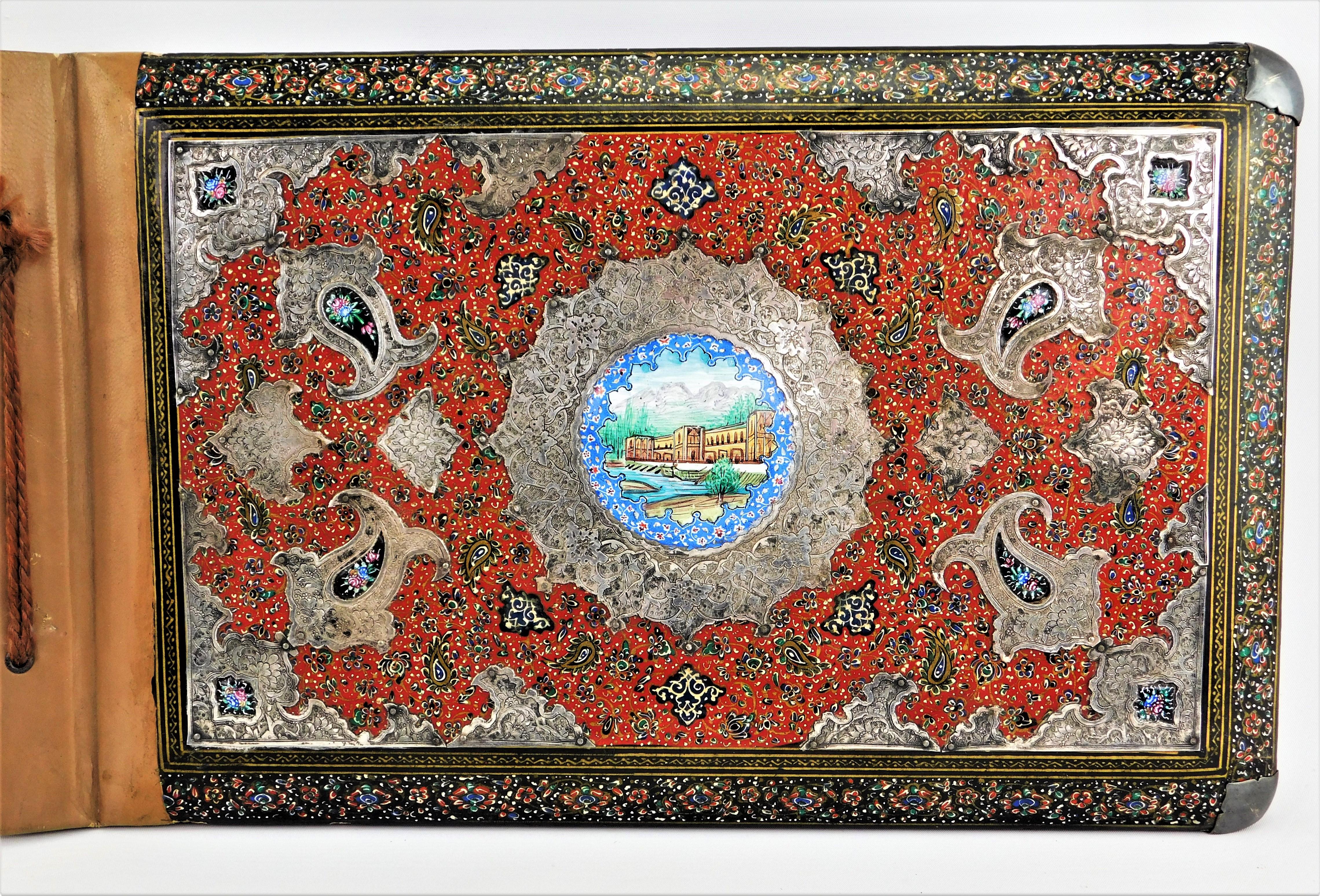 Late 19th century Middle Eastern photo album book, Qajar period, hand painted lacquer enamel with silver on leather large photo album. Painted enamel central plaque depicting a Mosque, silver corners and surrounds and a hand painted background. Back