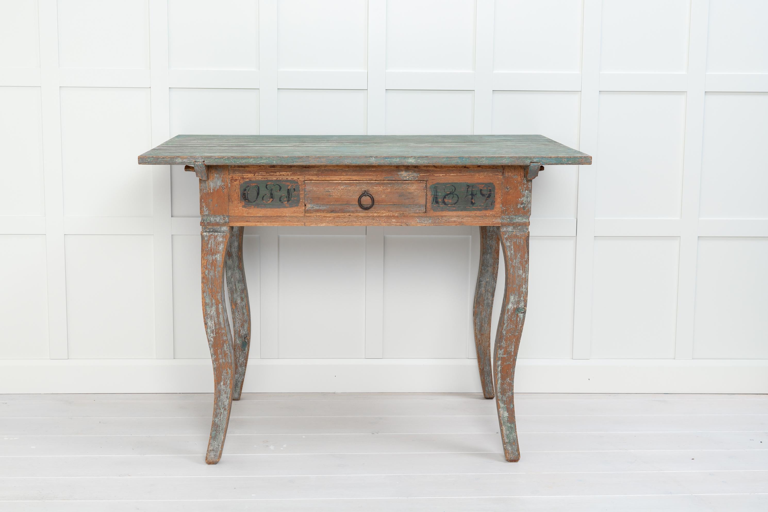 Antique Swedish handmade table in rococo style. The table is a country furniture with neat proportions and gently curved legs. The table is rococo which is explained by the fact that the furniture styles lived on in the countryside far longer than