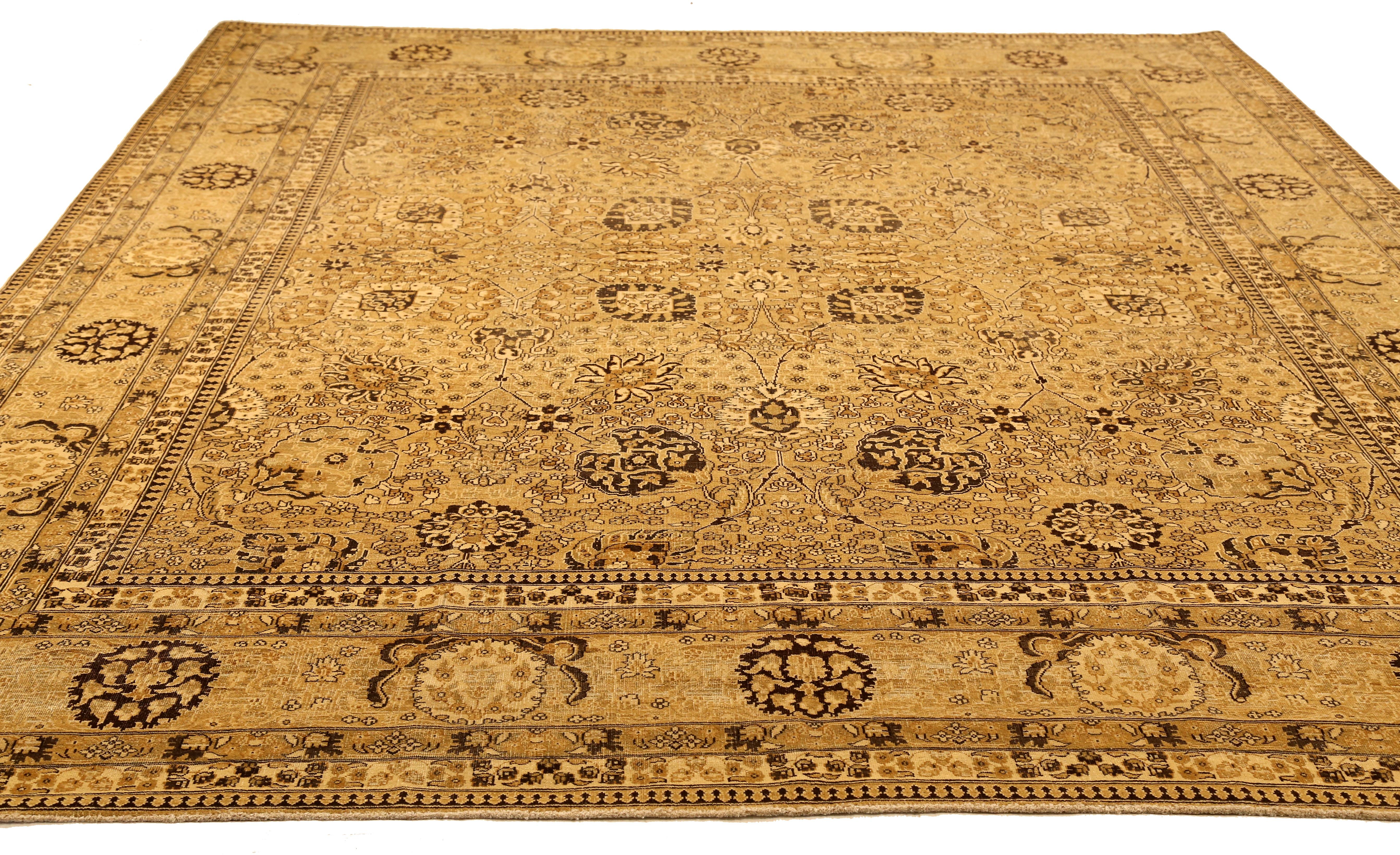 Antique mid-20th century hand-woven Turkish area rug made from fine wool and all-natural vegetable dyes that are safe for people and pets. It features traditional Tabriz weaving depicting intricate botanical and animal patterns often in bold colors.