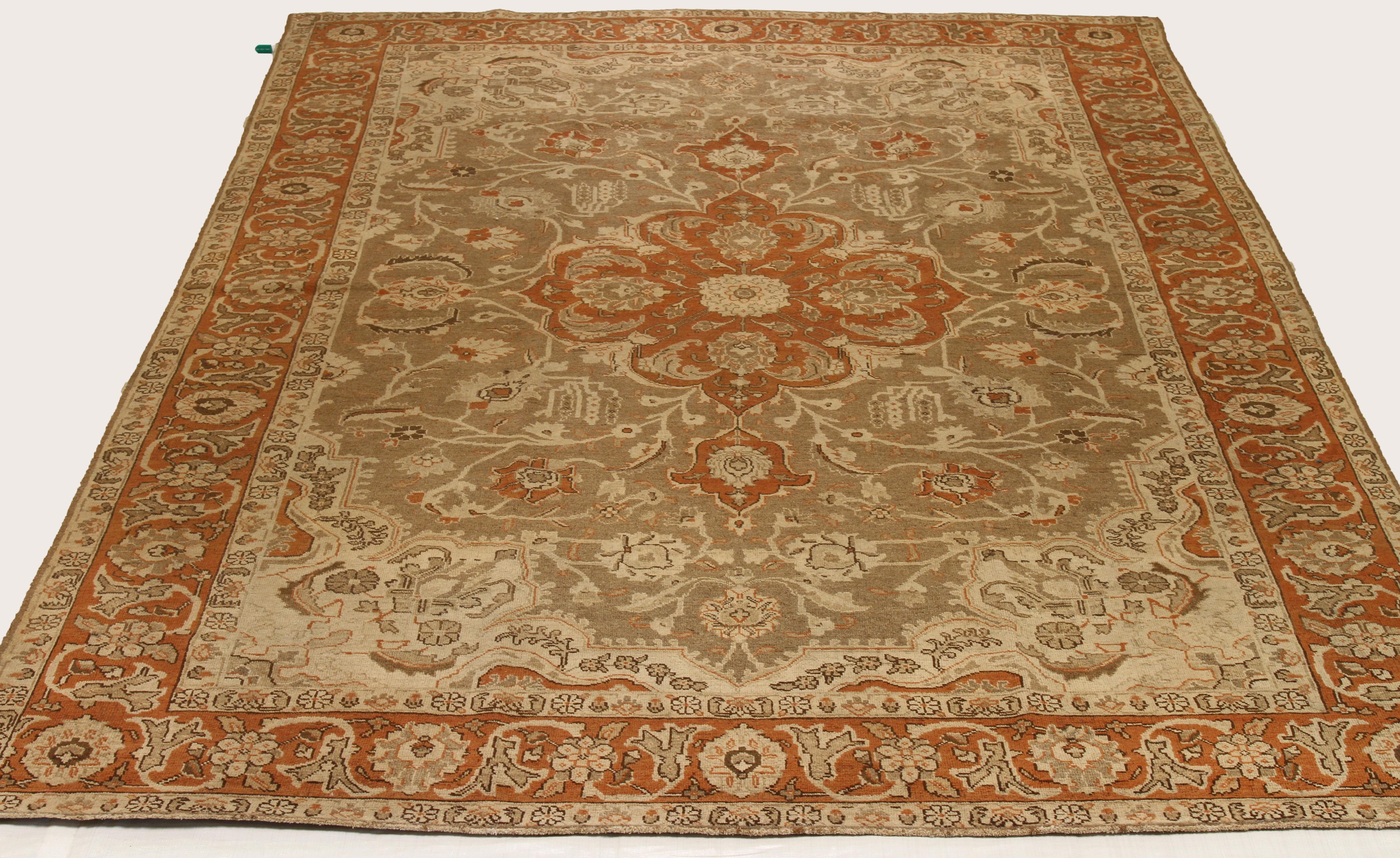 Antique mid-20th century hand-woven Persian area rug made from fine wool and all-natural vegetable dyes that are safe for people and pets. It features traditional Tabriz weaving depicting intricate botanical and animal patterns often in bold colors.