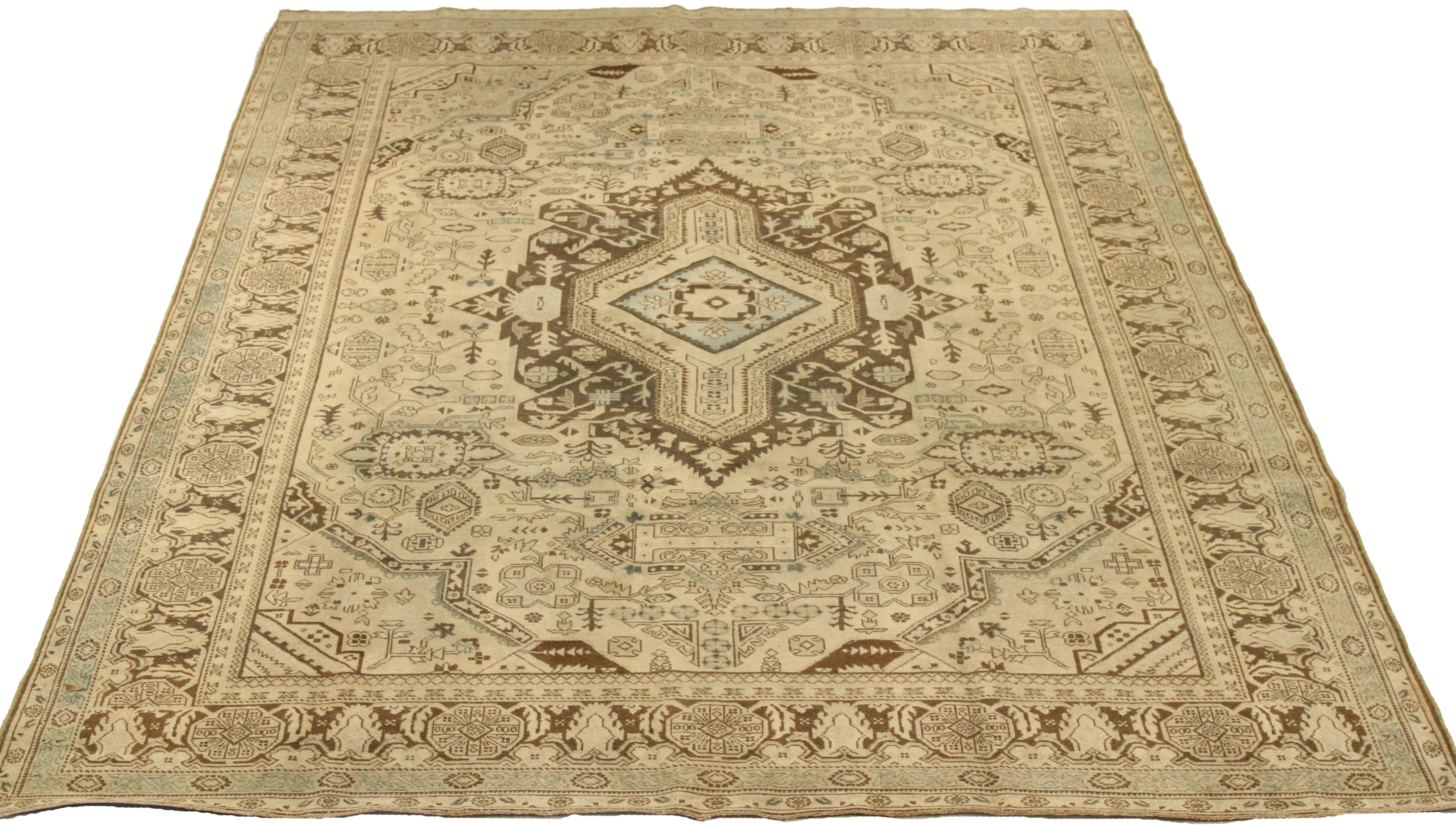 Antique mid-20th century hand-woven Persian area rug made from fine wool and all-natural vegetable dyes that are safe for people and pets. It features traditional Tabriz weaving depicting intricate botanical and animal patterns often in bold colors.