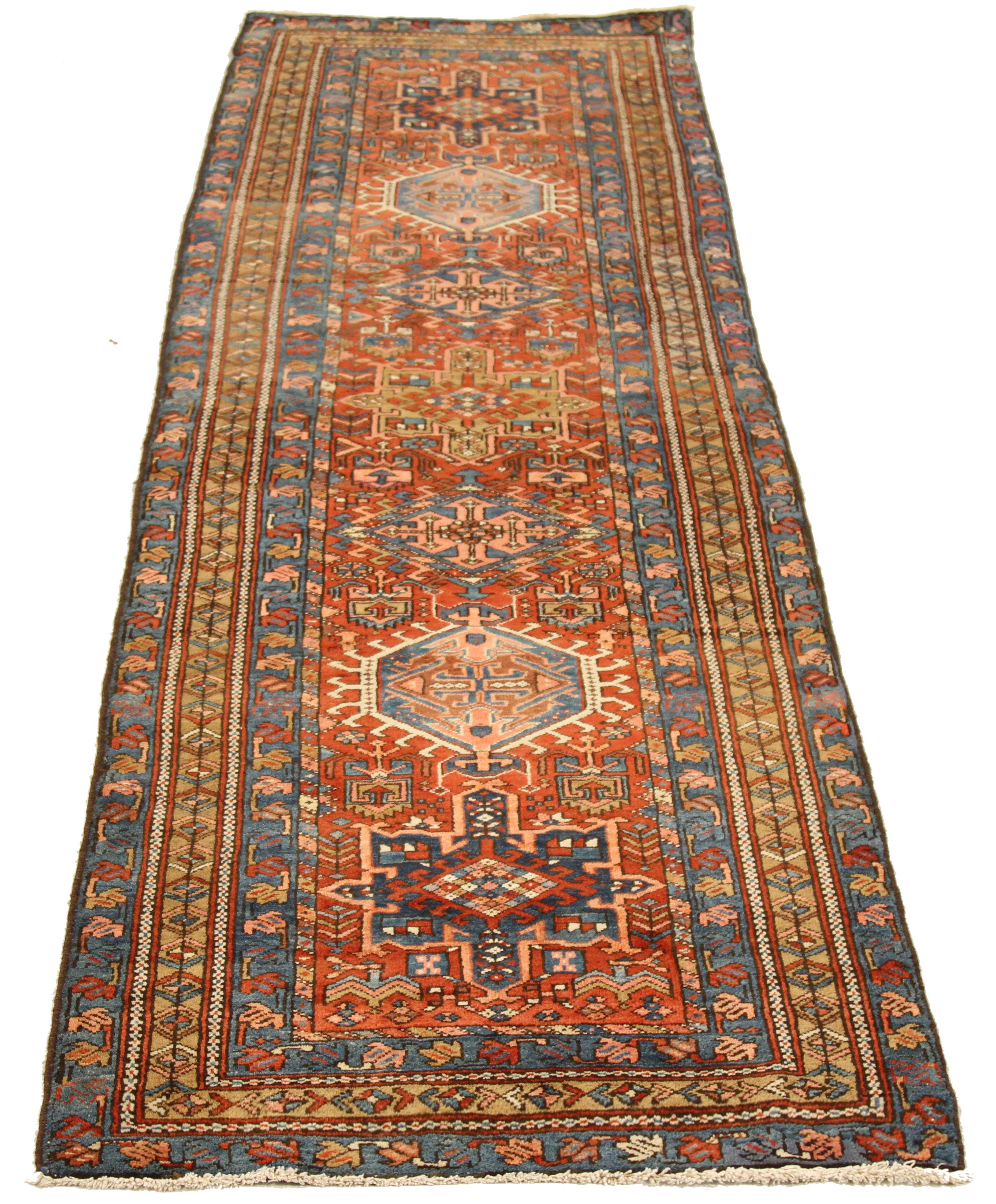 Antique mid-20th century handwoven Persian runner rug made from fine wool and all-natural vegetable dyes that are safe for people and pets. This beautiful piece features ornate floral patterns in various colors which Heriz rugs are known for.