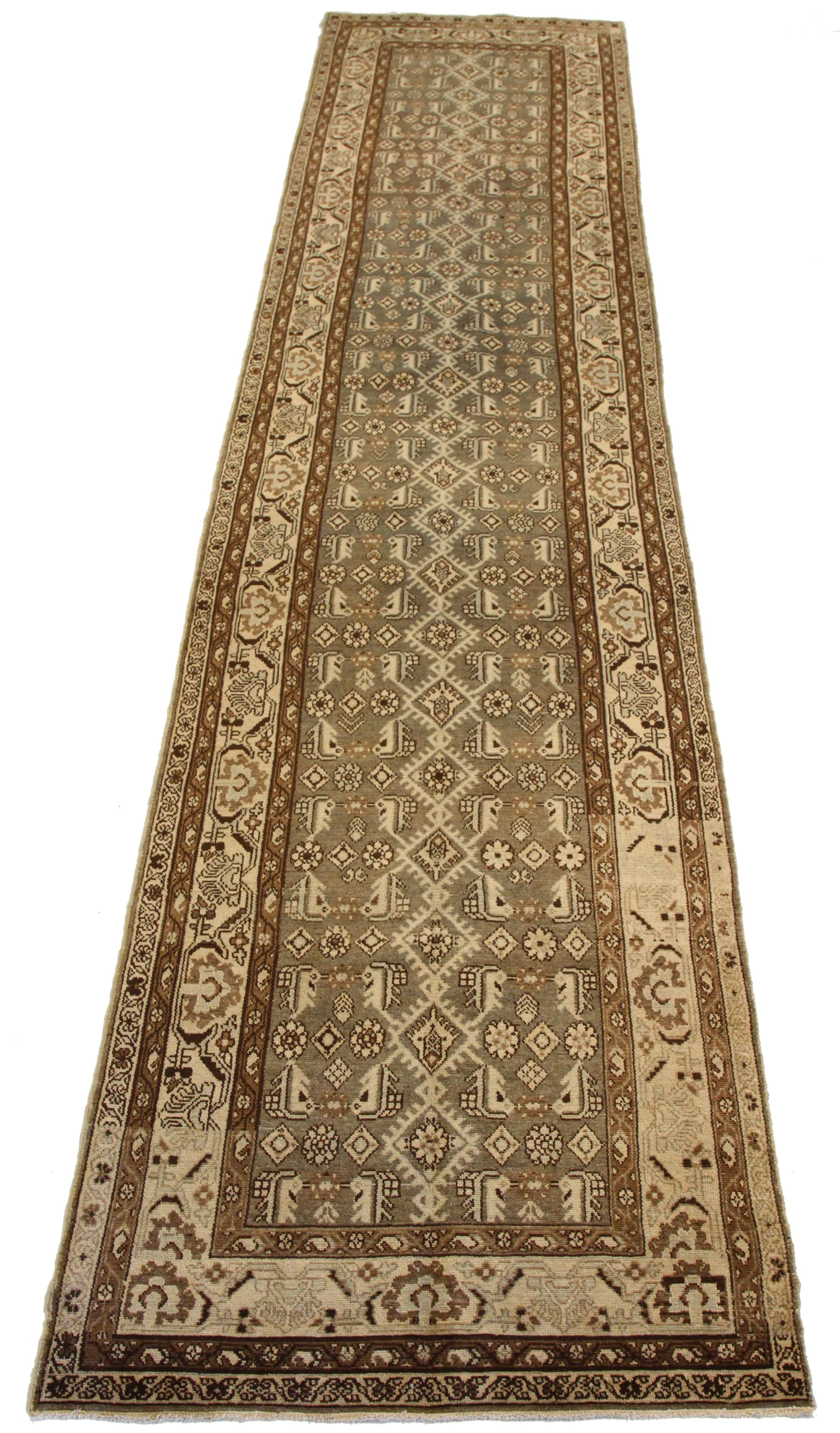 Antique hand-woven Persian runner rug made from fine wool and all-natural vegetable dyes that are safe for people and pets. It features traditional Malayer weaving depicting elaborate 'Boteh' patterns that represents life and eternity in Persian