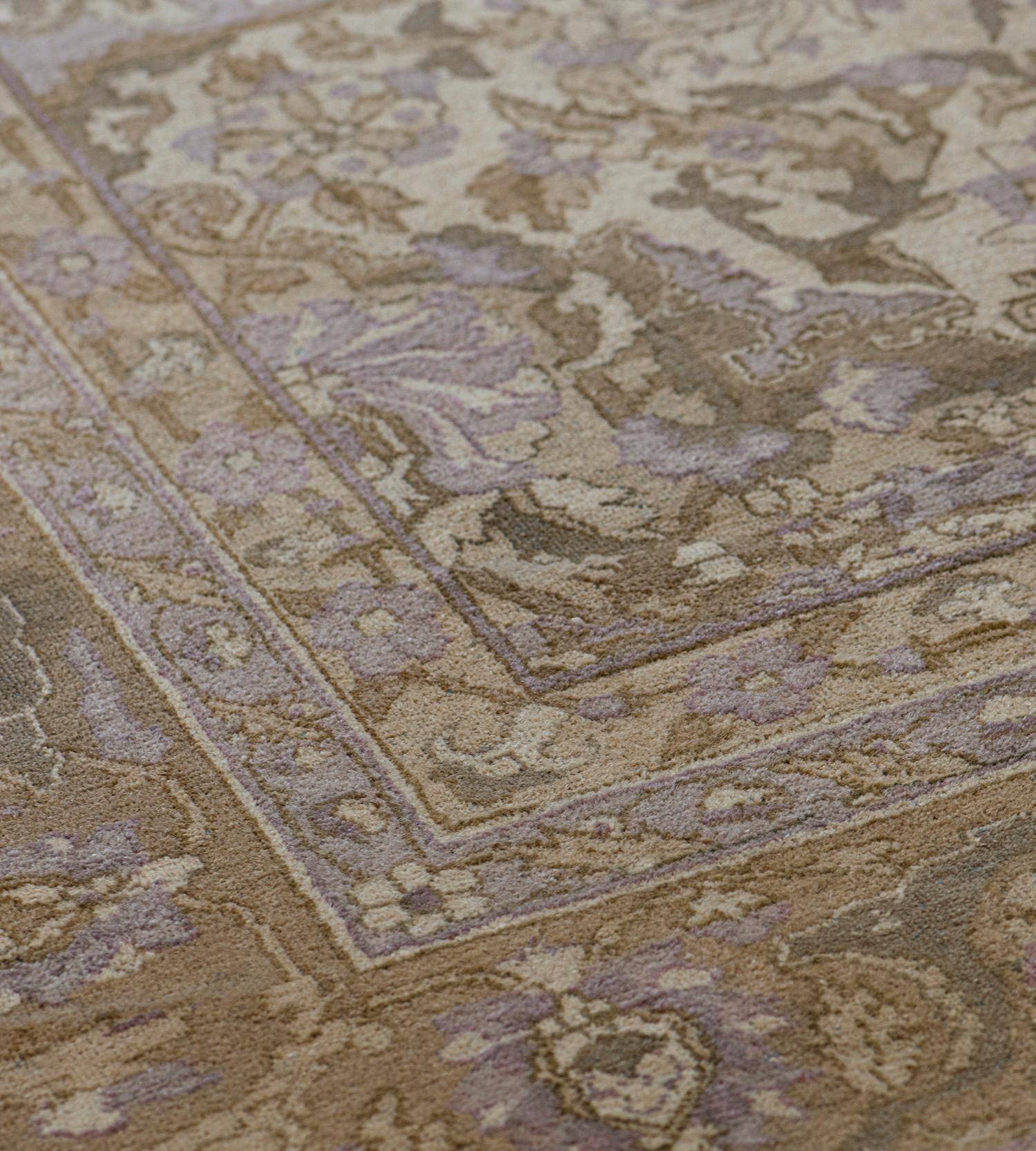 This antique handwoven wool Agra rug features an ivory field with an overall design of light purple and shaded brown dense floral and palmette vine around a column of similarly colored vase motifs issuing floral motifs and part palmettes, the open