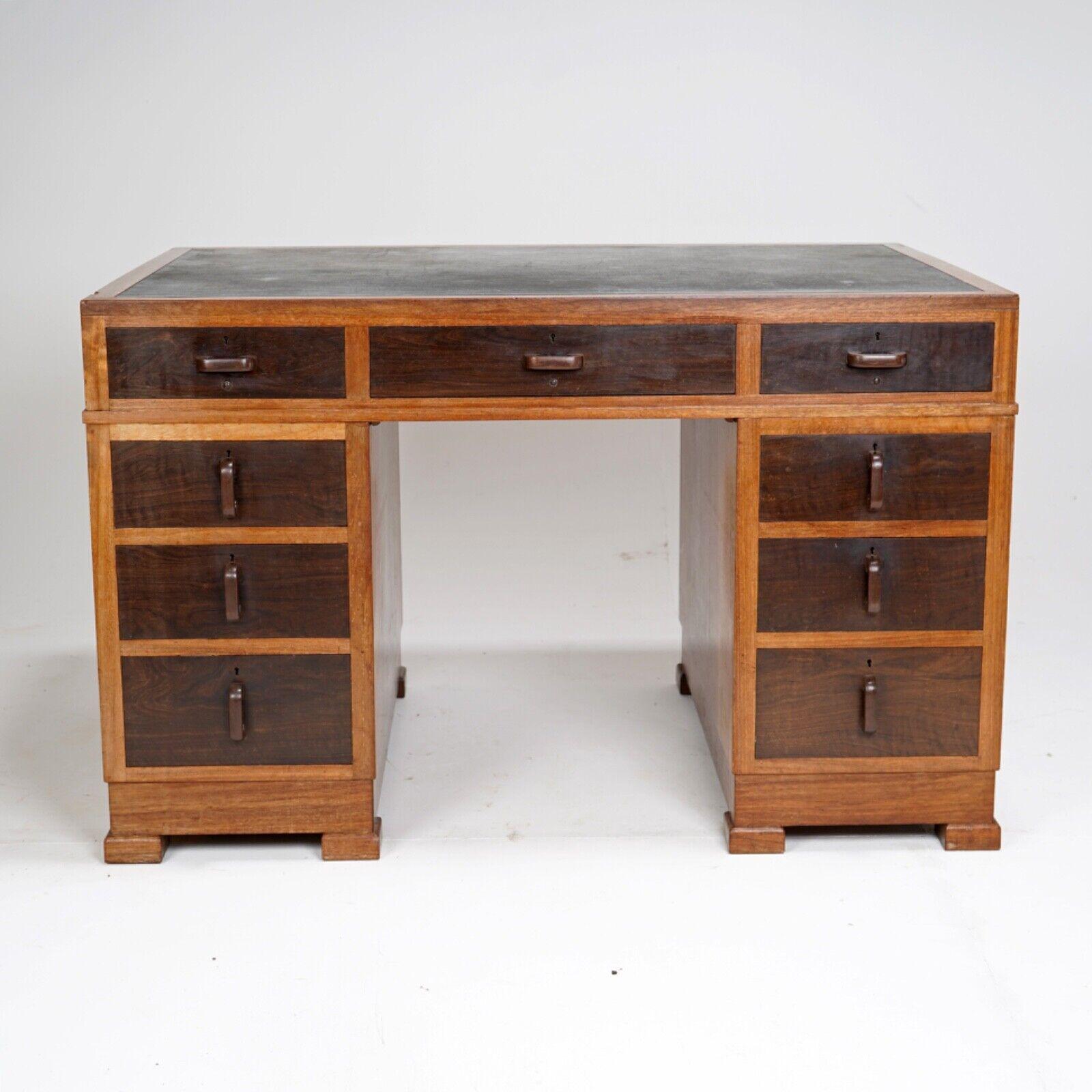 A superb quality English early to mid 20th century pedestal desk. 
The build quality of this desk is second to none. 
Fine hand cut dovetailed joints, drawers made from a finely figured hardwood matching handles that are made from the same