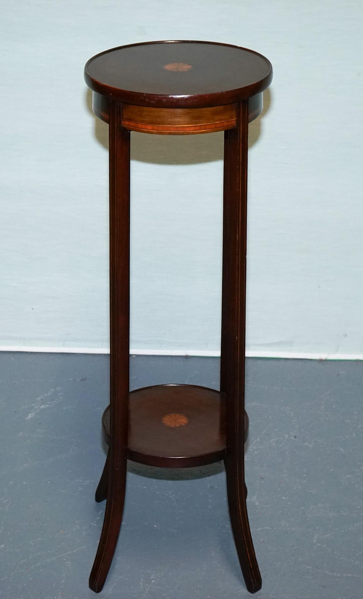 
Antiques of London



A fine antique hardwood two-tier plant stand dating to the early 20th century, featuring exquisite starburst marquetry inlay to both the circular top and lower shelf. The slender, gracefully flared legs evoke the refined lines