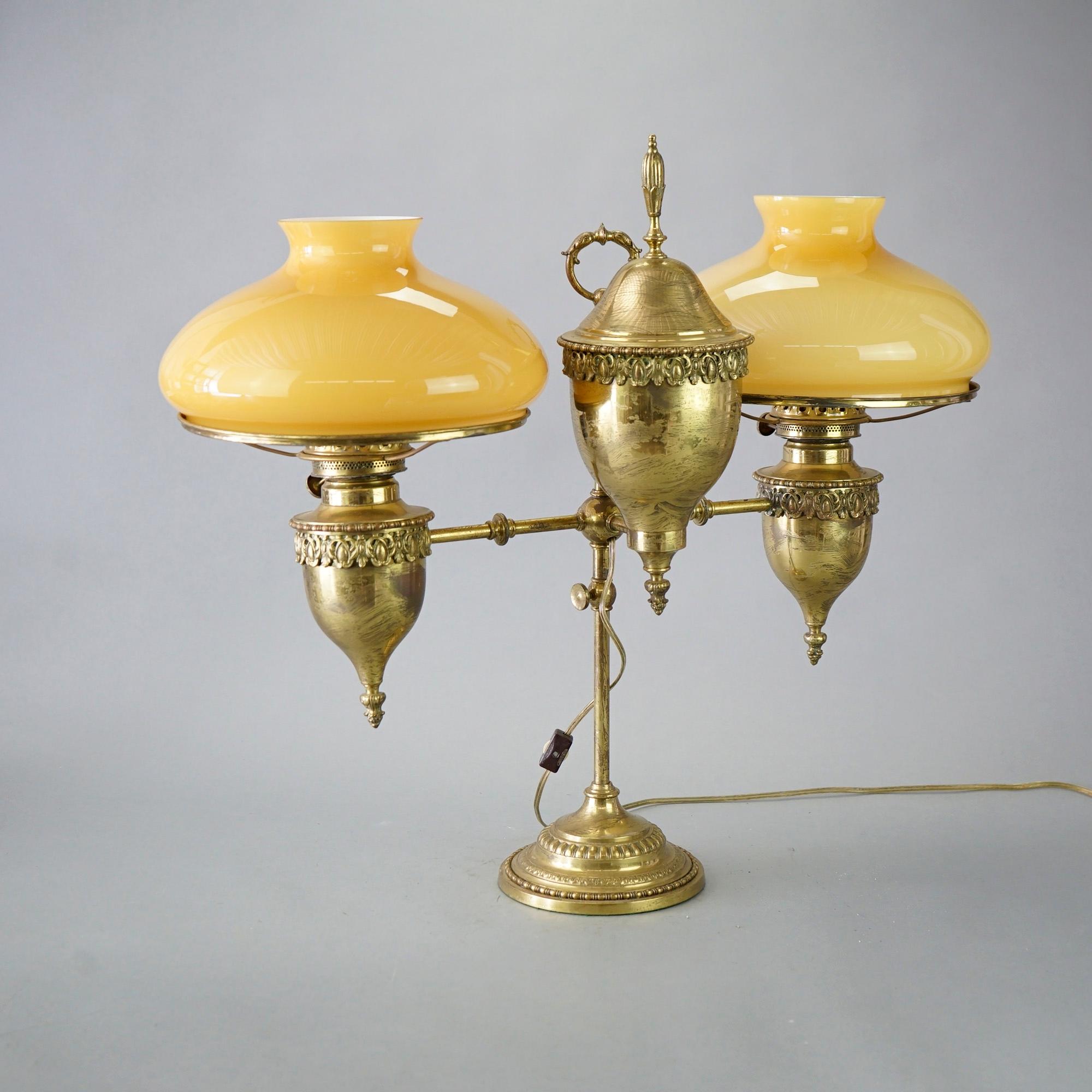 An antique Harvard student lamp offers brass frame having adjustable double arms terminating in cased glass shades, electrified, c1890

Measures- 23.75'' H x 26'' W x 12'' D.

Catalogue Note: Ask about DISCOUNTED DELIVERY RATES available to most