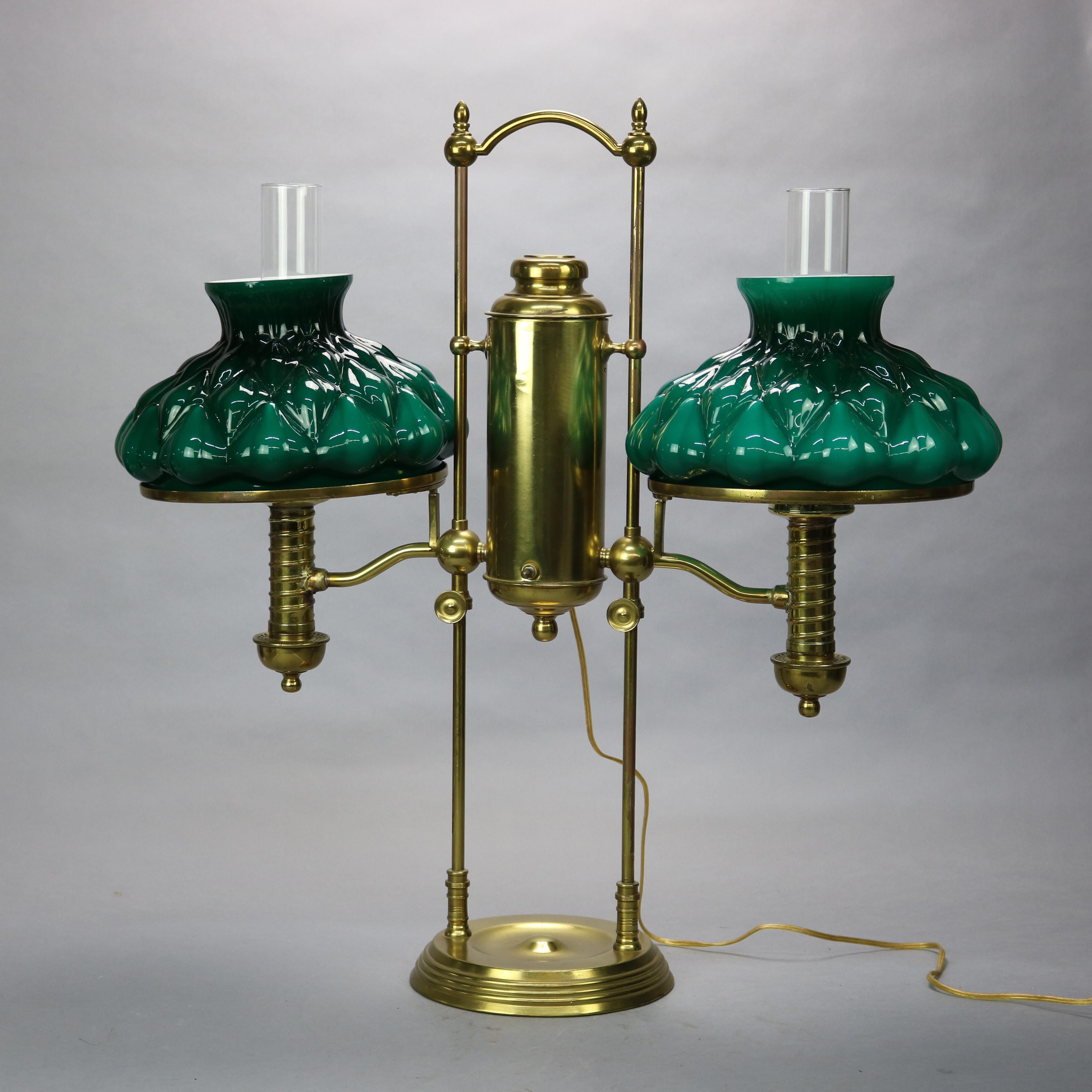 An antique Harvard school student lamp offers brass construction with central font having flanking adjustable lights with newer molded emerald cased glass shades, c1890

Measures: 28.75