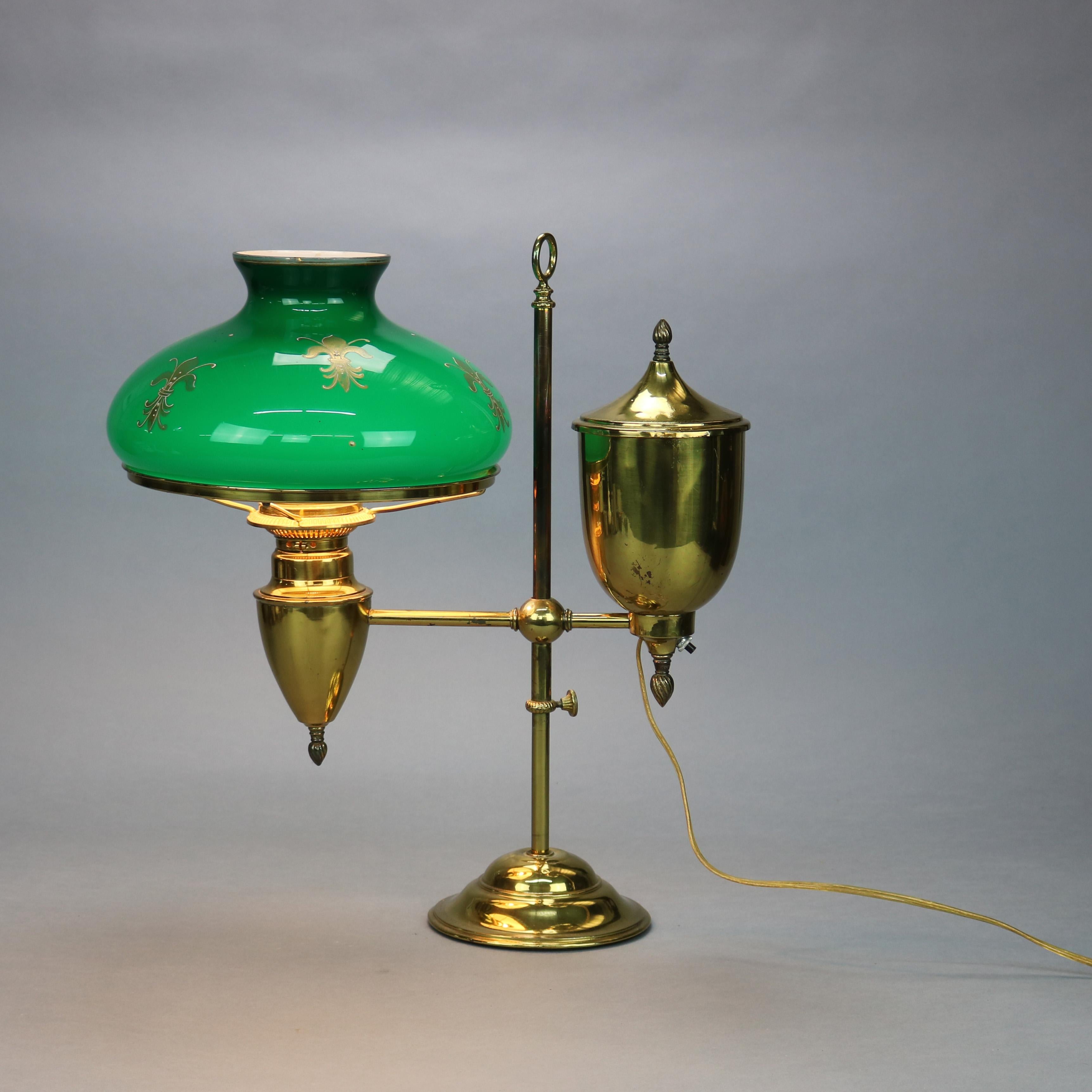 An antique Harvard School student lamp offers brass frame with urn form fonts and adjustable arm having gilt decorated green cased glass shade, 20th century.


Measures: 19.5