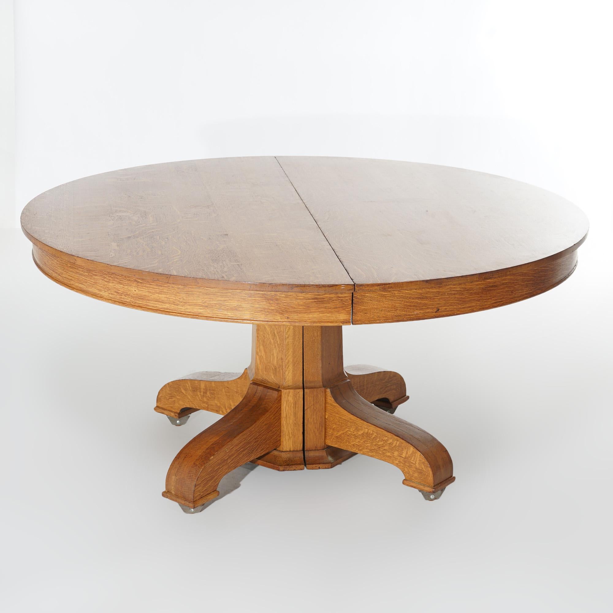 An antique Hastings Arts and Crafts Mission extension dining table offers quarter sawn oak construction with a round top over faceted pedestal raised on four legs, accepts four leaves, c1920

Measures - 60