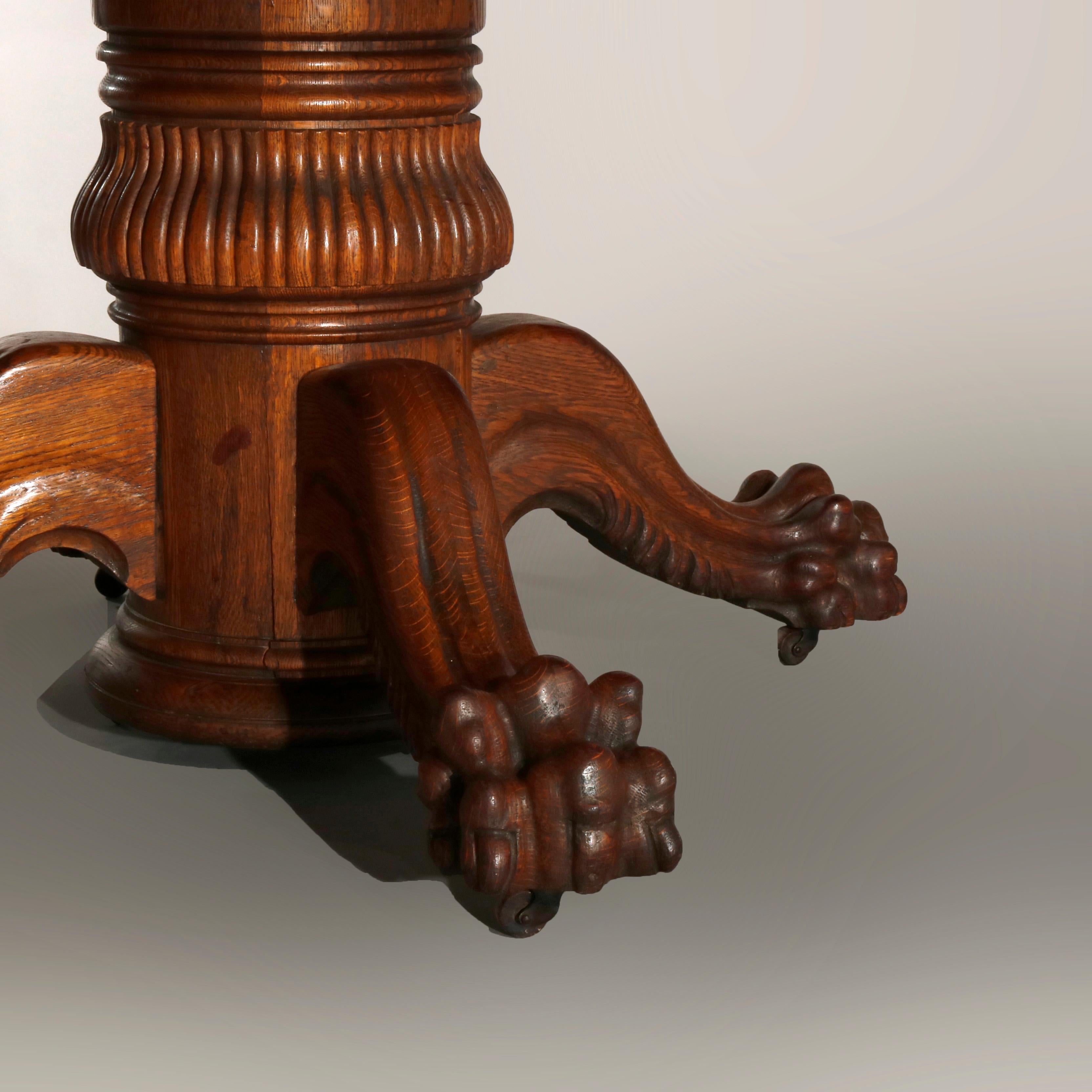 Metal Antique Hastings Carved Oak Claw Foot Split Pedestal Dining Table, circa 1910