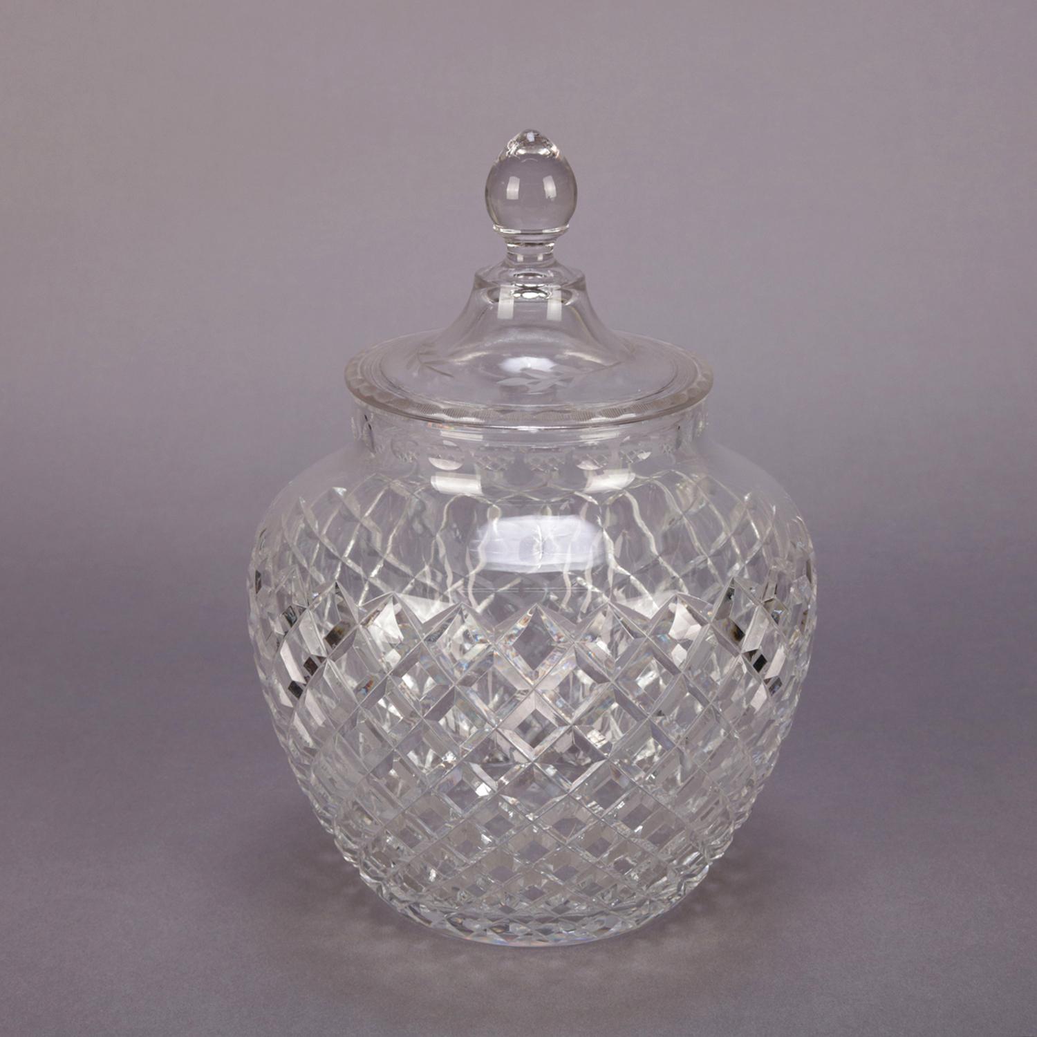 An antique American brilliant cut glass lidded jar by Hawkes features bowl with diamond cut pattern and finial lid, signed on base, 20th century.

Measures: 9