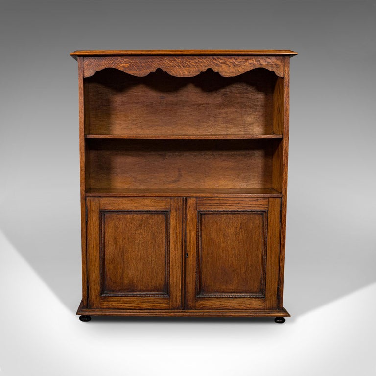 This is an antique headmaster's office bookcase. An English, oak cabinet, dating to the Edwardian period, circa 1910.

Attractive carved forms and wood grains
Displaying a desirable aged patina - in good order throughout
Select oak offers fine
