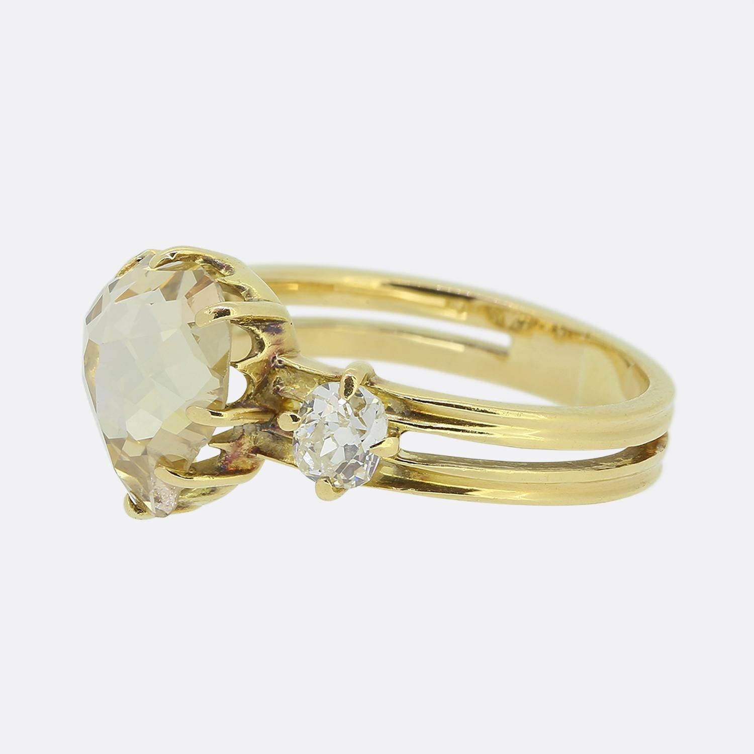 Here we have a gorgeous diamond ring dating back to the Edwardian period. This antique 18ct gold piece exudes romance with a chunky heart-shaped rose cut diamond taking centre stage. This proud principal stone is then flanked on either side by a