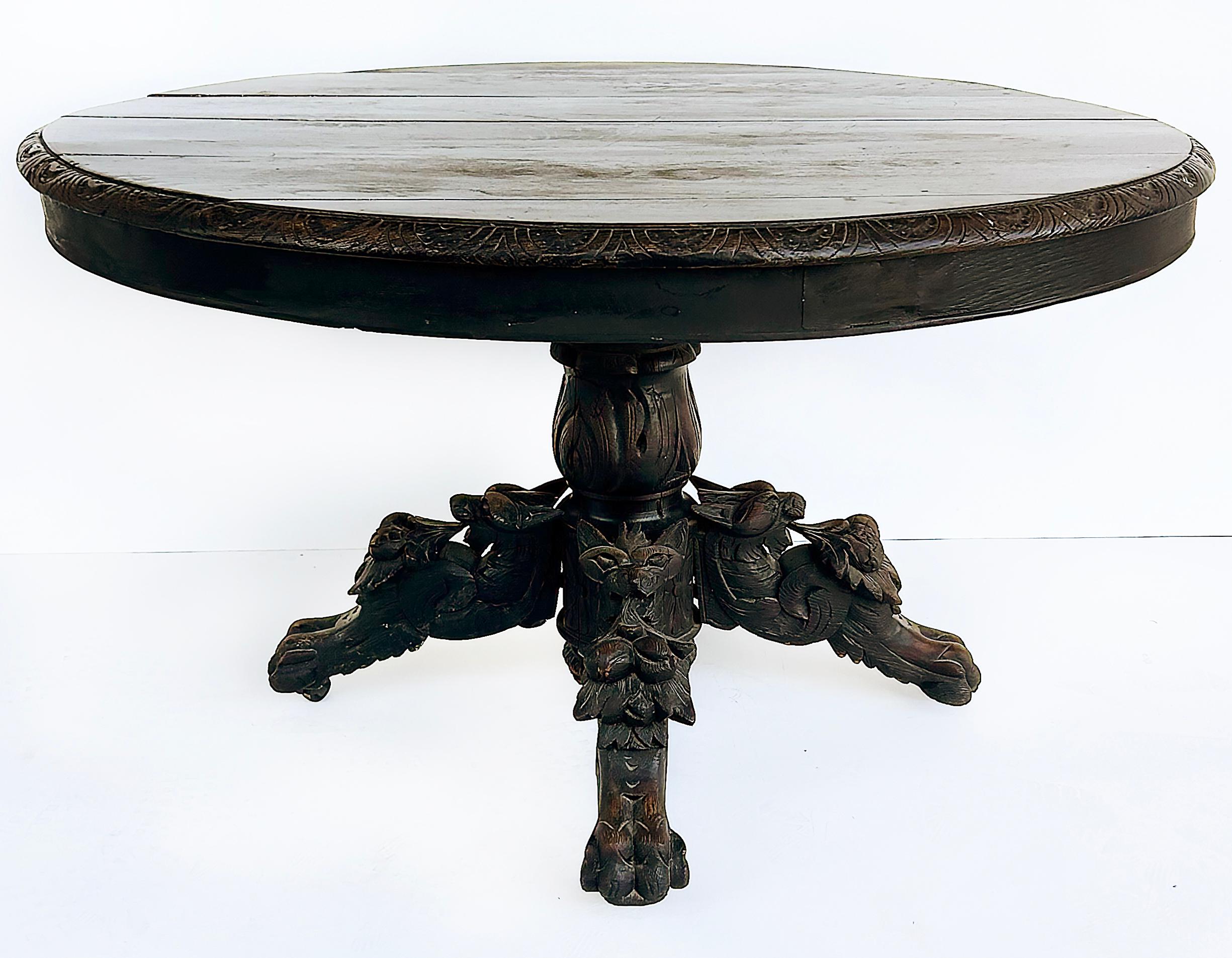 Antique Heavily Carved Griffins Wood Center, Game Table

Offered for sale is an antique European heavily carved pedestal table with four legs.  Each of the legs is adorned with heavily carved griffins that extend down to paw feet. The top of the
