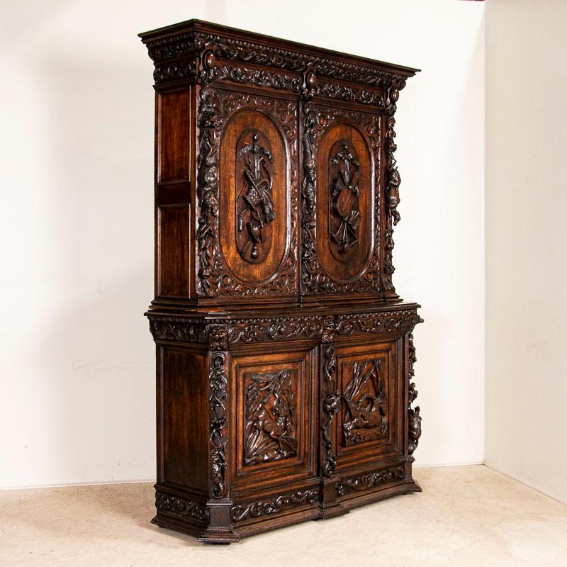 Dramatic carved oak hunt cabinet from France; carved images include but are not limited to stag, geese, foul, wild boar, nuts, leaves, musical lyre and more. The cabinet is made in 2 sections, the upper cabinet resting upon the lower sideboard.