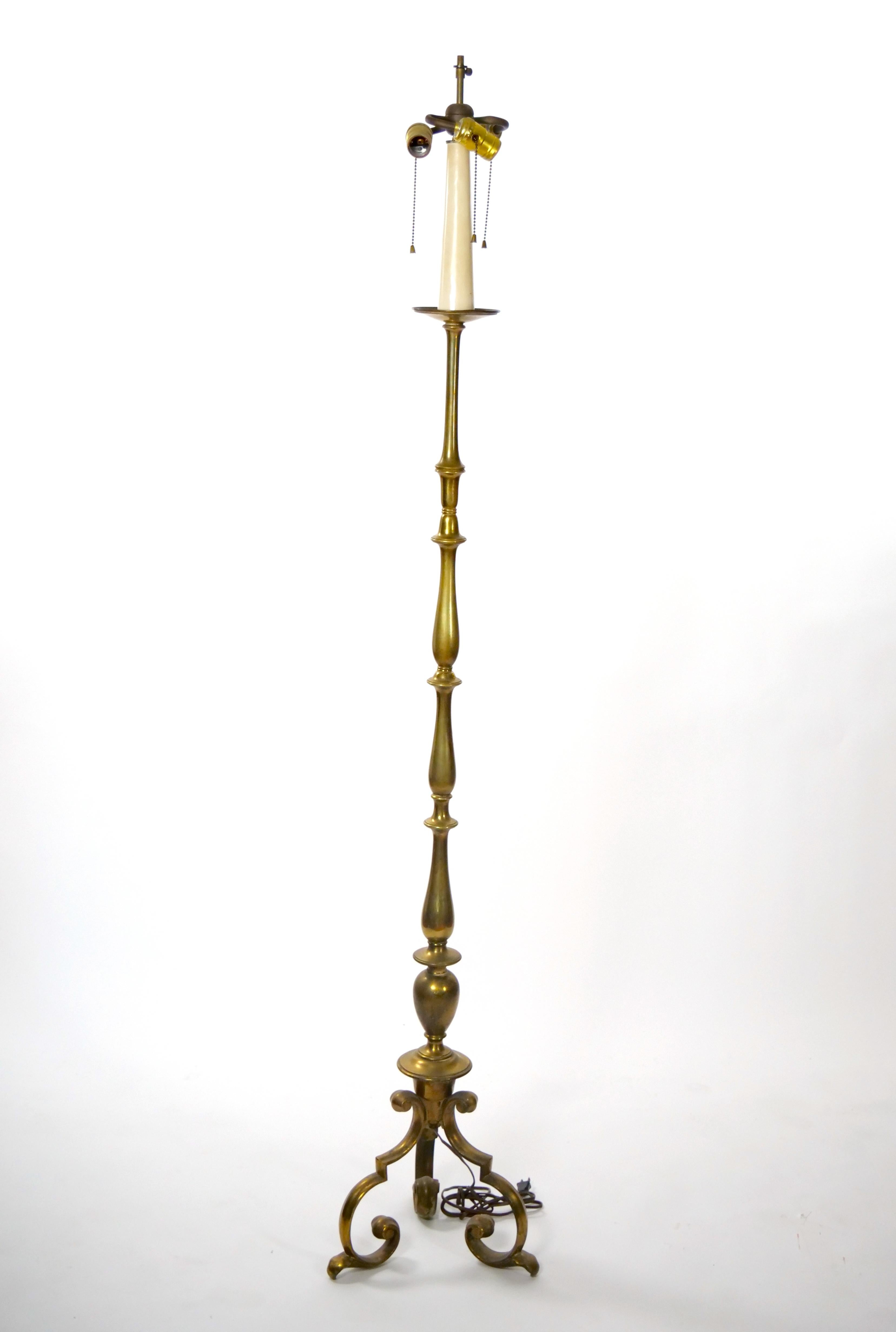 Presentamos una impresionante lámpara de pie de latón pesado del siglo XIX, elegantemente colocada sobre una base trípode con volutas. Esta elegante lámpara presenta intrincados detalles de diseño exterior, que le confieren un toque de encanto