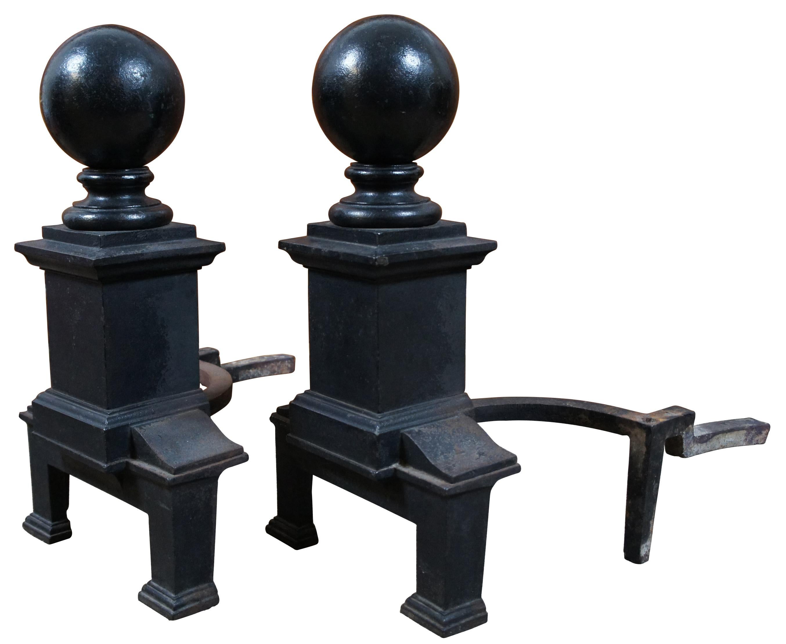 Antique black cast iron fireplace andirons with cannon ball tops and broad square column bases. Casting mark of 1962 on underside. An exceptional and heavy set. Measure: 20