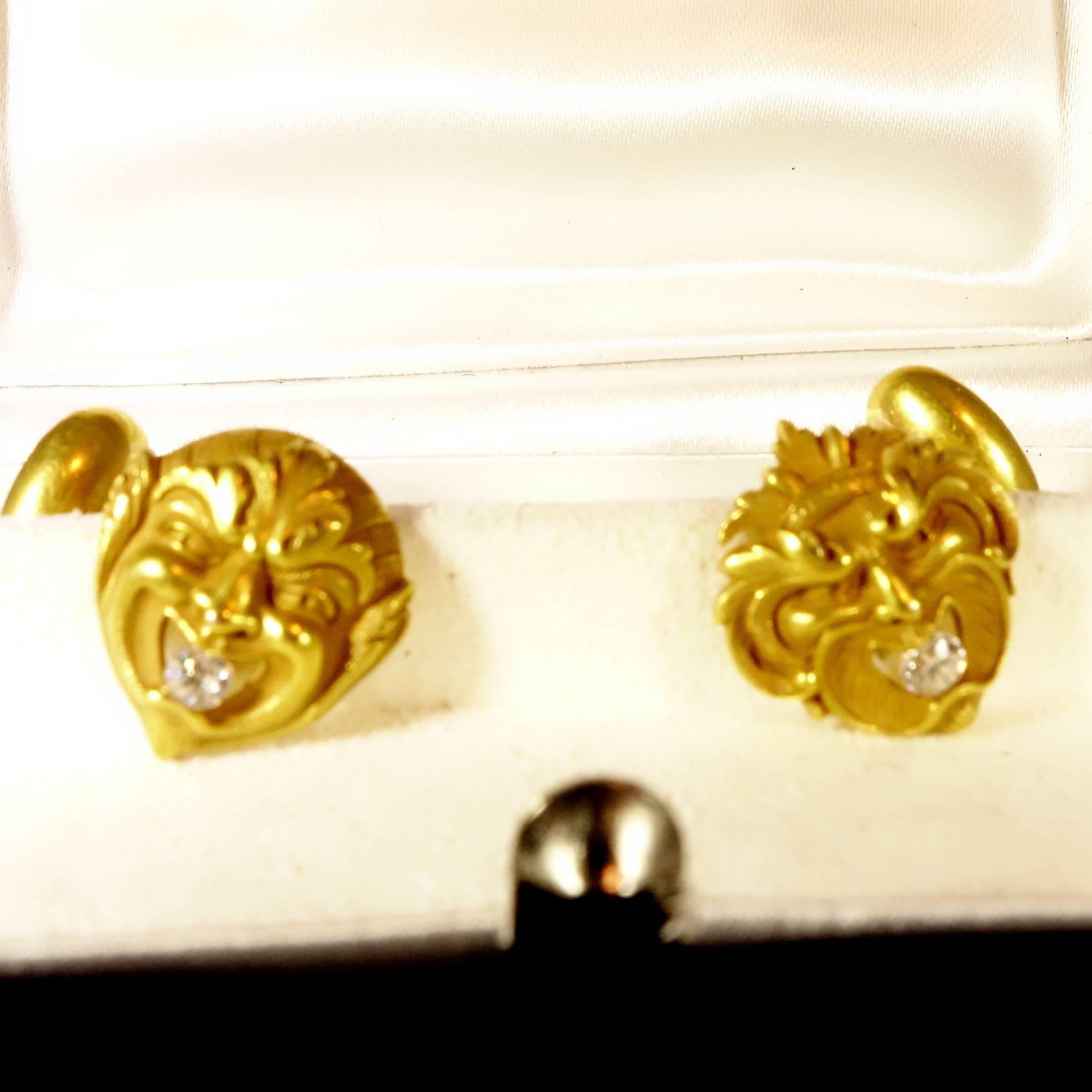 Unusual and  well done cufflinks with an European cut diamond, formerly from the collection of Janet Zapata, noted jewelry historian, the different masks  hold a white old diamond,  in its mouth weighing a total of .20 cts.   Circa 1880's and