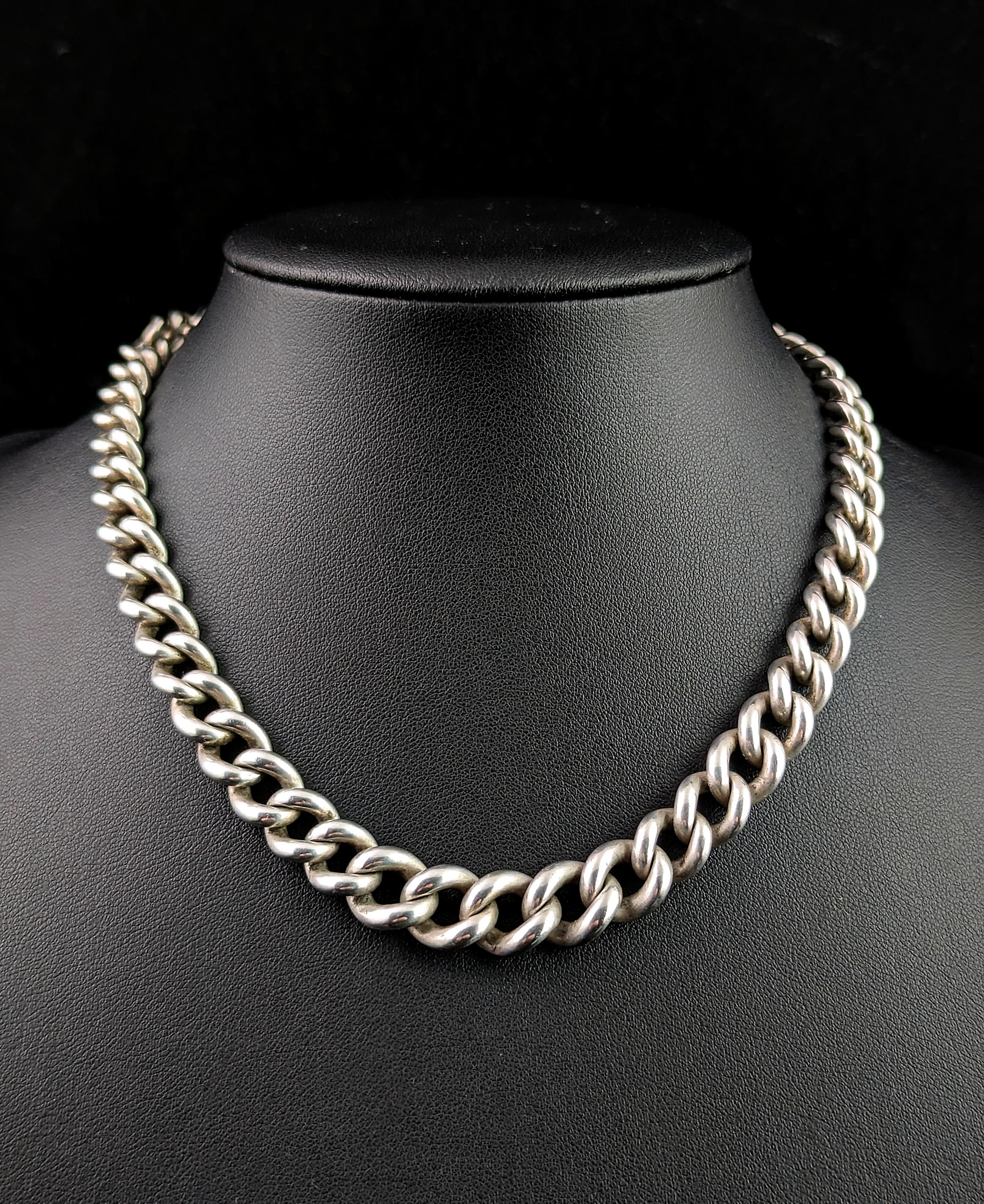 You can't help but fall in love with this handsome antique Albert chain.

It is a sterling silver chain with a chunky and heavy graduating curb link with a dog clip fastener to one end and a T bar and short chain length to the other.

Each link is