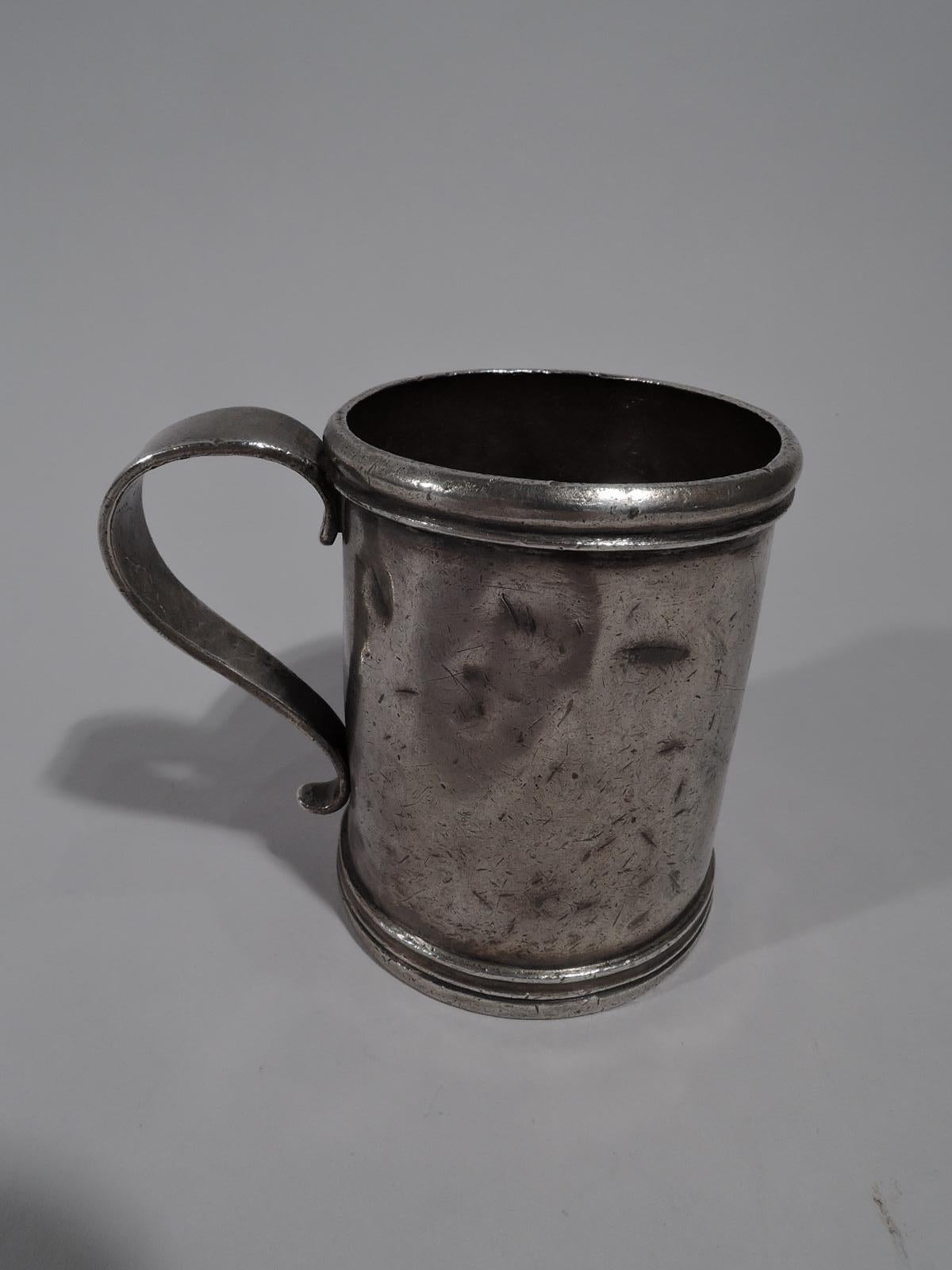 South American silver mug, early 19 century Straight sides with s-scroll handle and molded rim and base. Script initials engraved on underside. Heavy weight: 8 troy ounces.