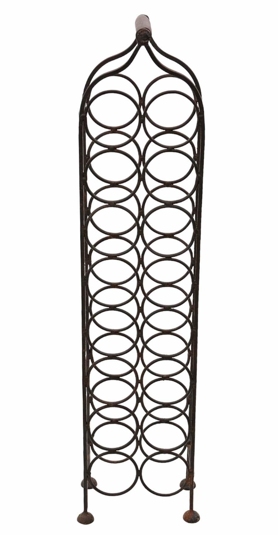 Antique wrought iron wine rack, dating back to circa 1920 or possibly earlier, designed to hold 16 bottles.

Embracing an old, rustic charm, this piece boasts sturdy construction with no loose joints or woodworm damage.

Featuring a desirable age