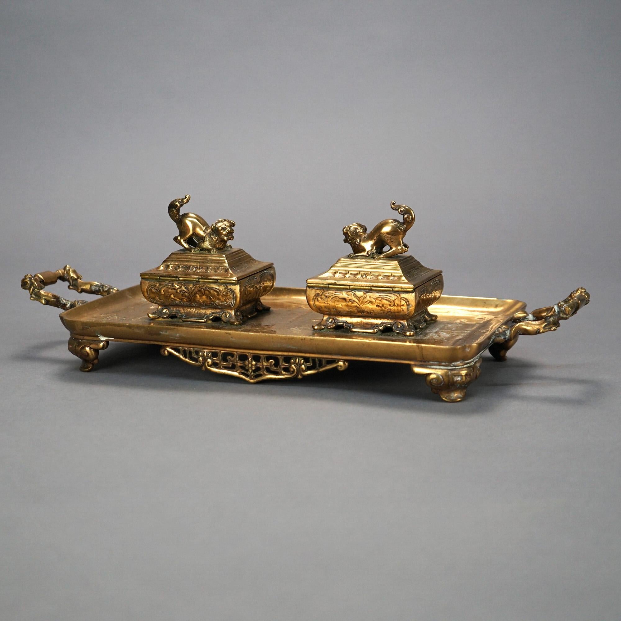 An antique Henry Dasson figural Orientalist inkwell set offers gilt bronze construction with two inkwells, each having foo dog finials, seated on a footed tray, c1910

Measures- 4.5'' H x 15.5'' W x 5.75'' D.