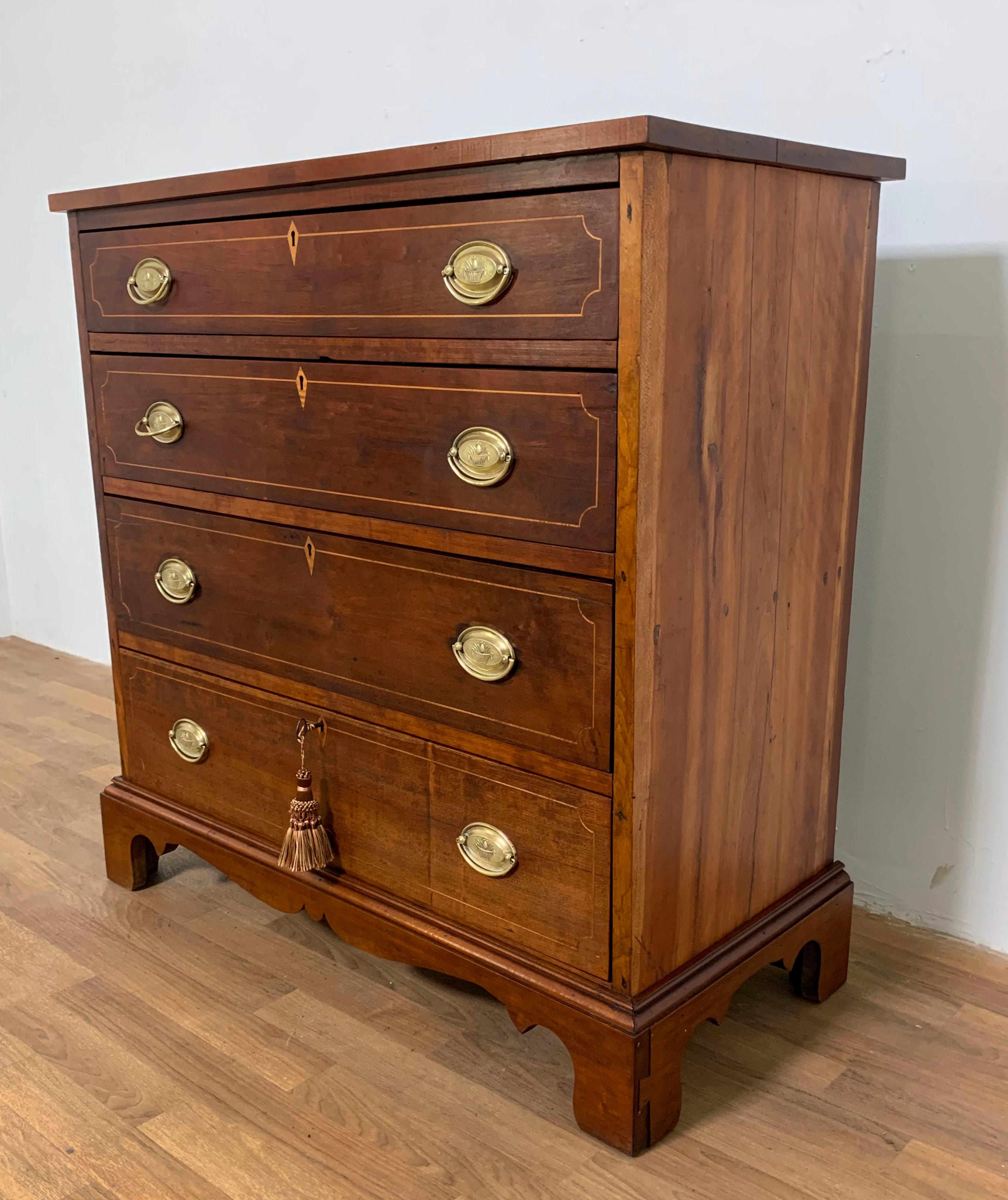 Ca. 1800s Hepplewhite mahogany chest of four string inlayed drawers. Original brasses which have been recently polished. As the secondary wood is oak, this most likely is of English origin. Note the key does not turn in the lock and is for