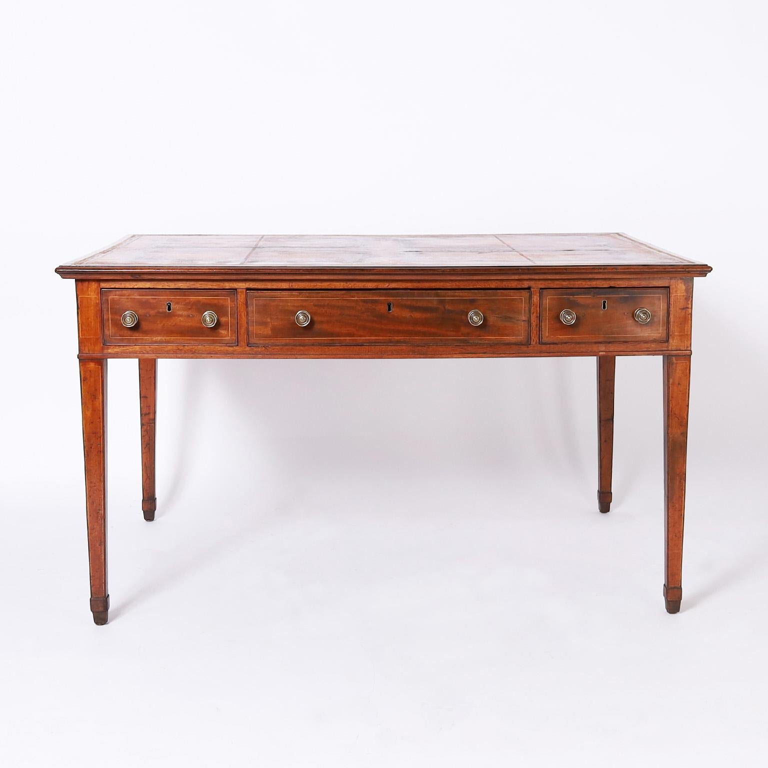 Rare and remarkable early 19th century Hepplewhite partners desk having the original tooled leather top in a crossbanded border, a case with three drawers in each side with beechwood string inlaid highlights and elegant tapered legs on spade feet.