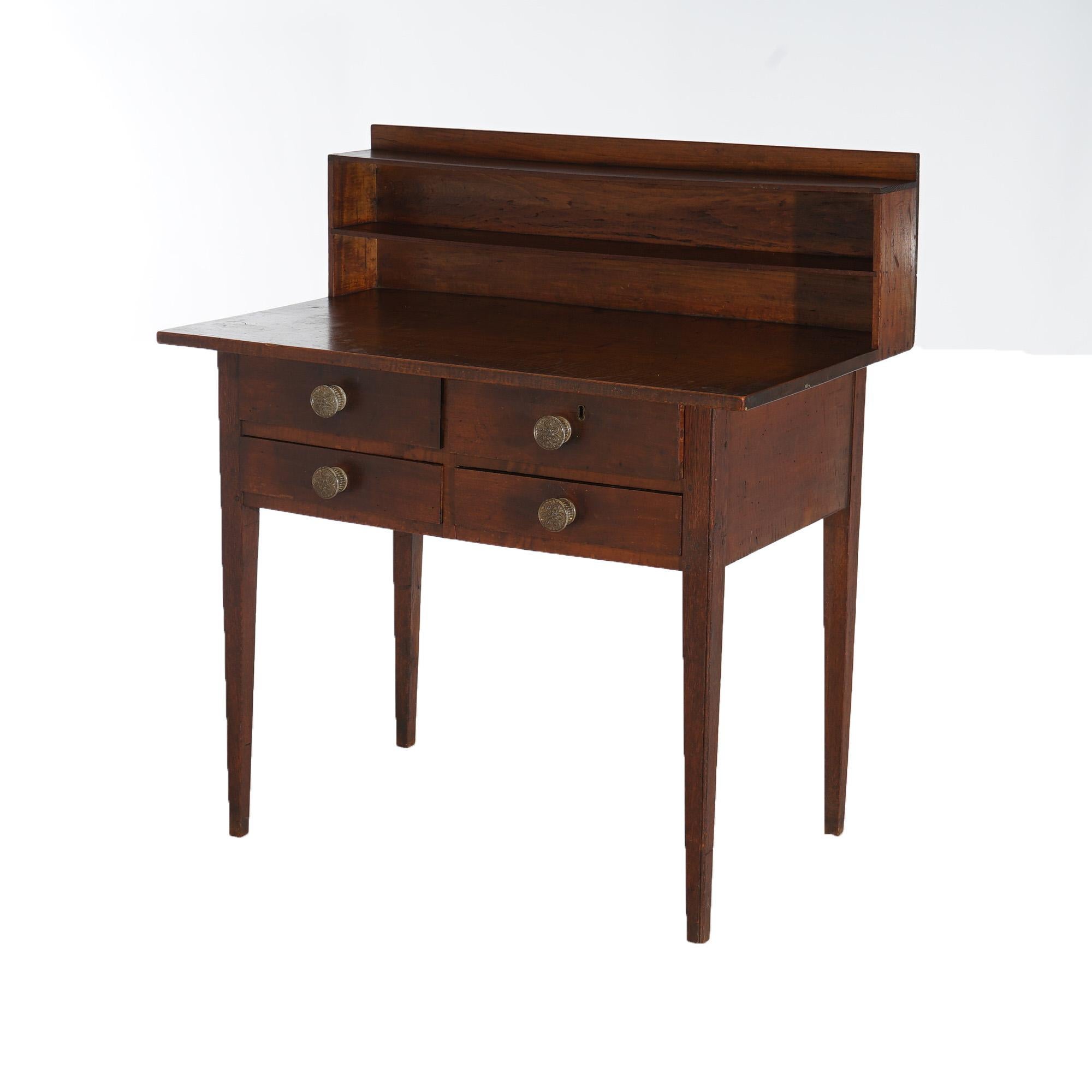An antique Hepplewhite Shaker school writing desk offers tiger maple and cherry construction with upper storage compartments, four drawers and raised on square and tapered legs; provenance card as photographed; c1830

Measures - 39.75