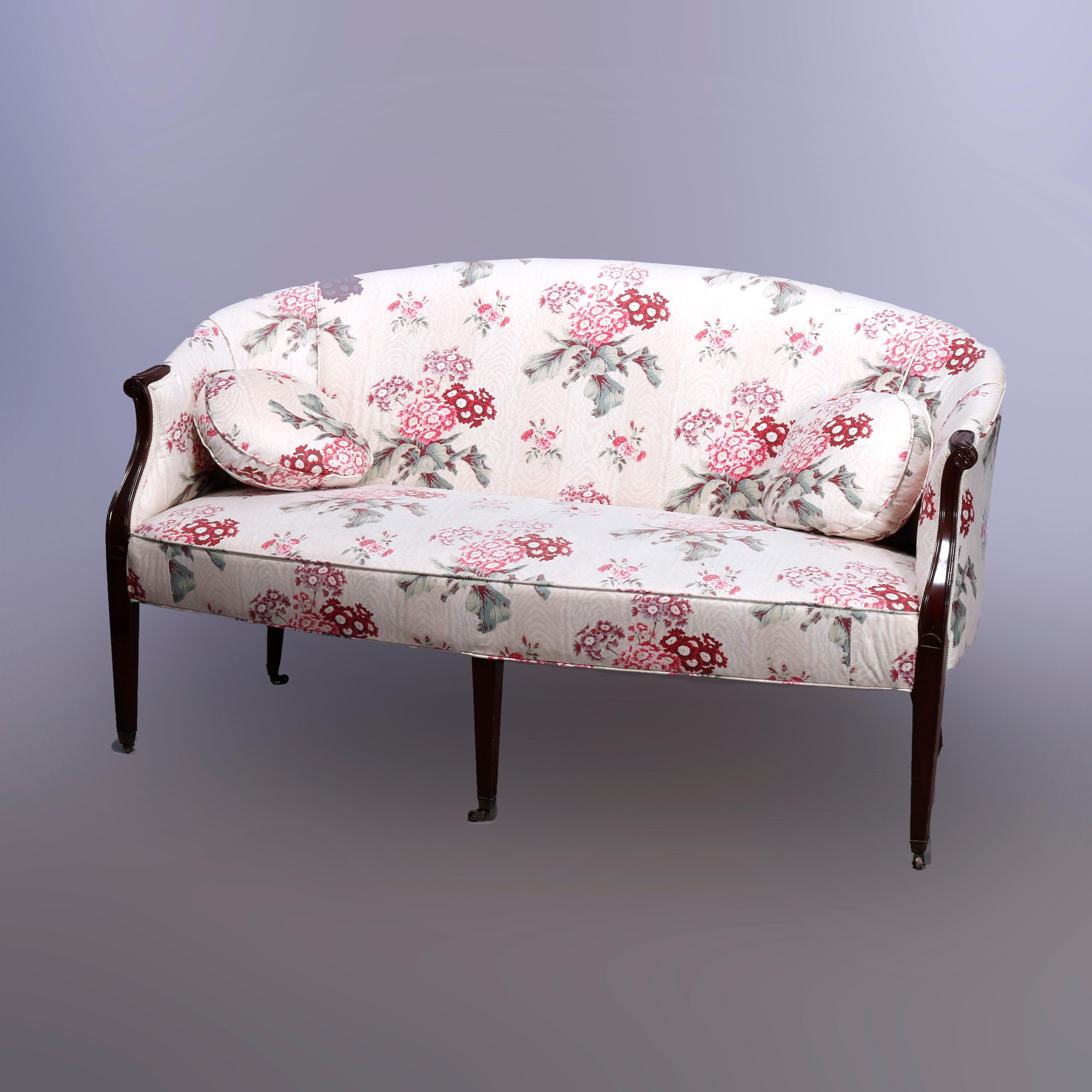An antique Hepplewhite style settee offers arched and curved back with mahogany frame having scroll arms with carved rosettes and raised on square and tapered legs, floral upholstered, c1930
 
Measures - 34.5''H x 61''W x 33''D; seat height