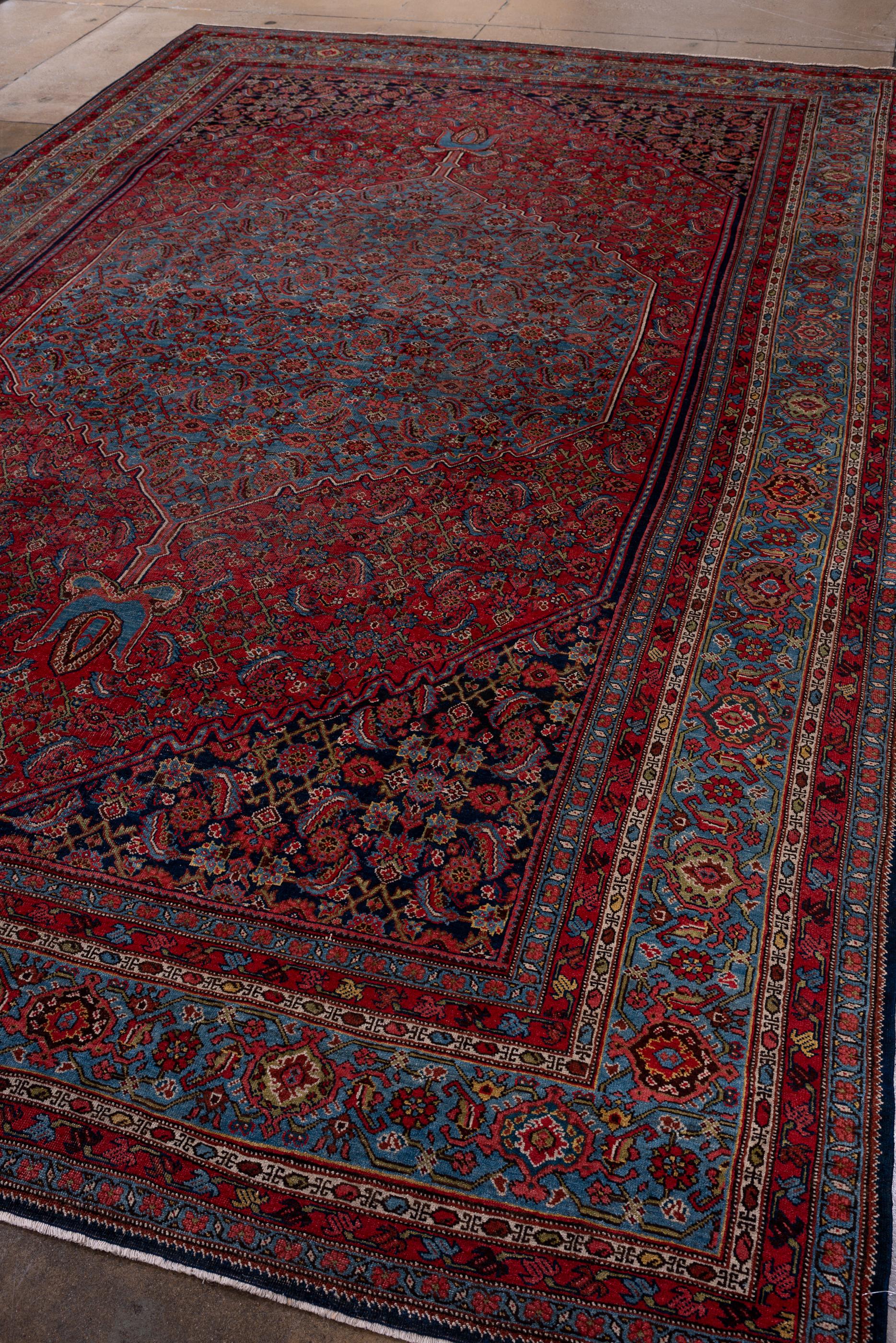 Persian Antique Herati Design with Red Field and Navy Blue Border For Sale