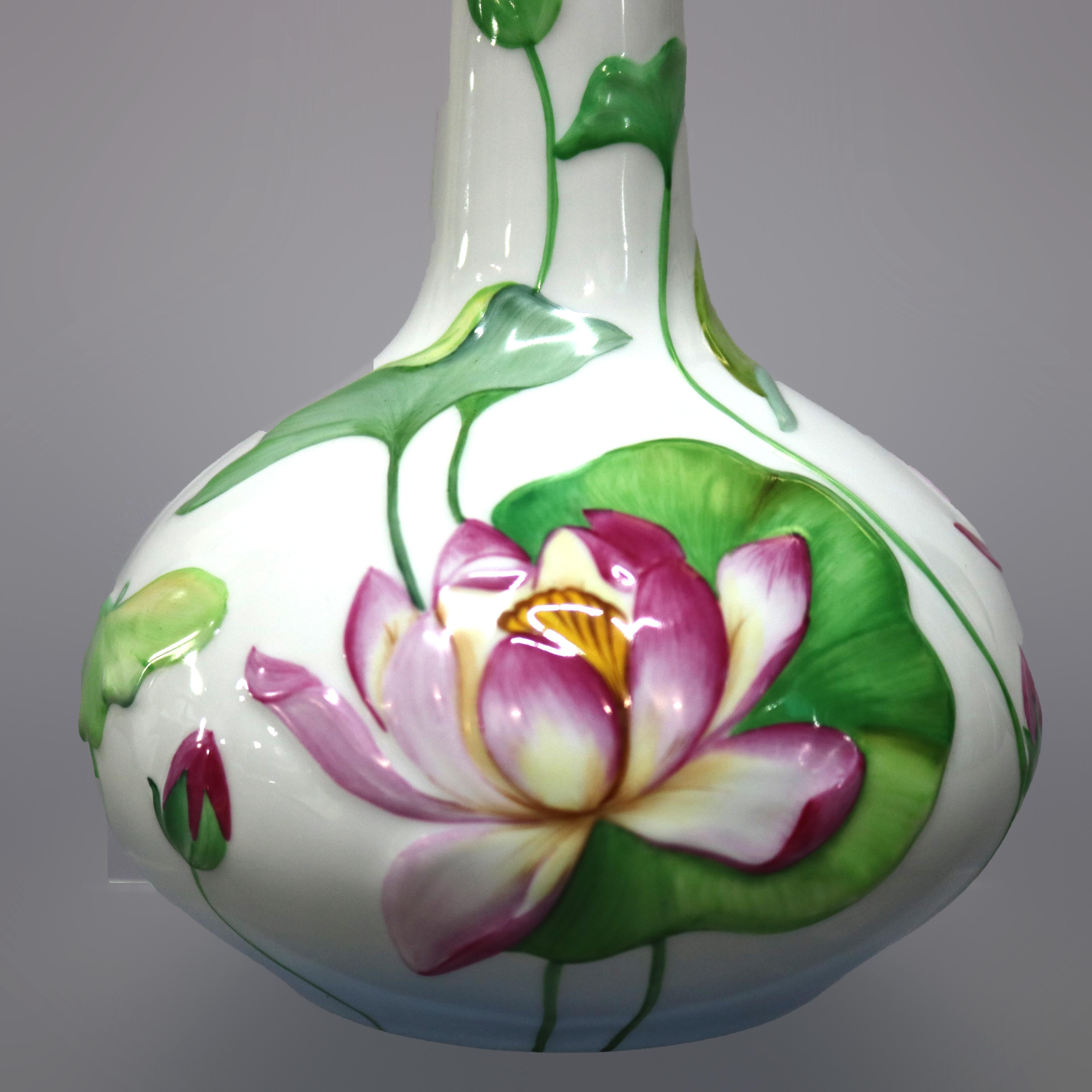 An antique vase by Herend, Hungary offers porcelain construction with hand painted lily pads and flowers, 20th century. 

Measures: 11.25