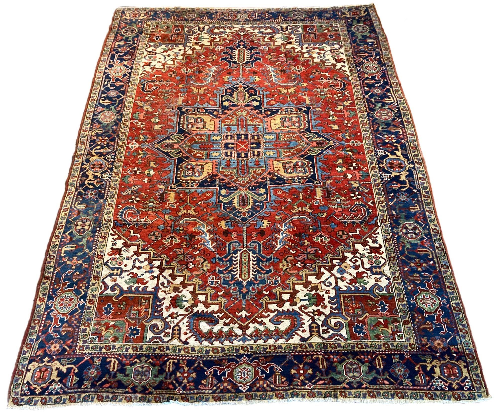 A beautiful antique Heriz carpet, handwoven circa 1920 with a large geometrical medallion on a terracotta field and deep indigo border. Fabulous secondary colours, especially the large ivory corner spandrels and a highly decorative piece.
Size: