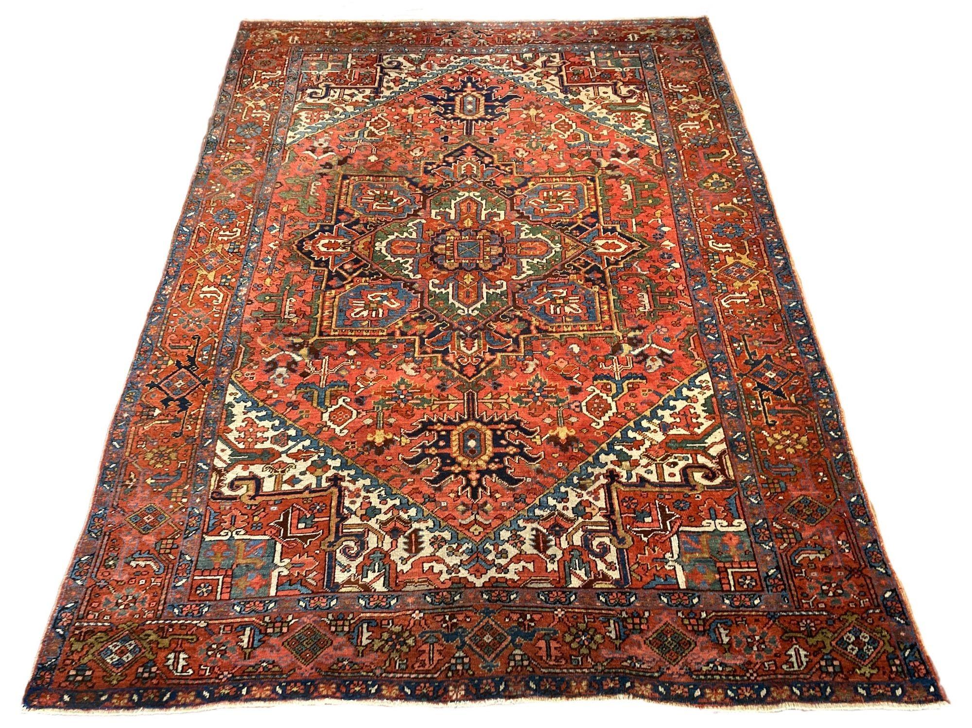 An outstanding antique Heriz carpet, handwoven circa 1920 with a traditional geometrical design on a terracotta field and, unusually, a similar coloured border. Some stunning secondary colours that would look fabulous in any interior.
Size: 3.41m x