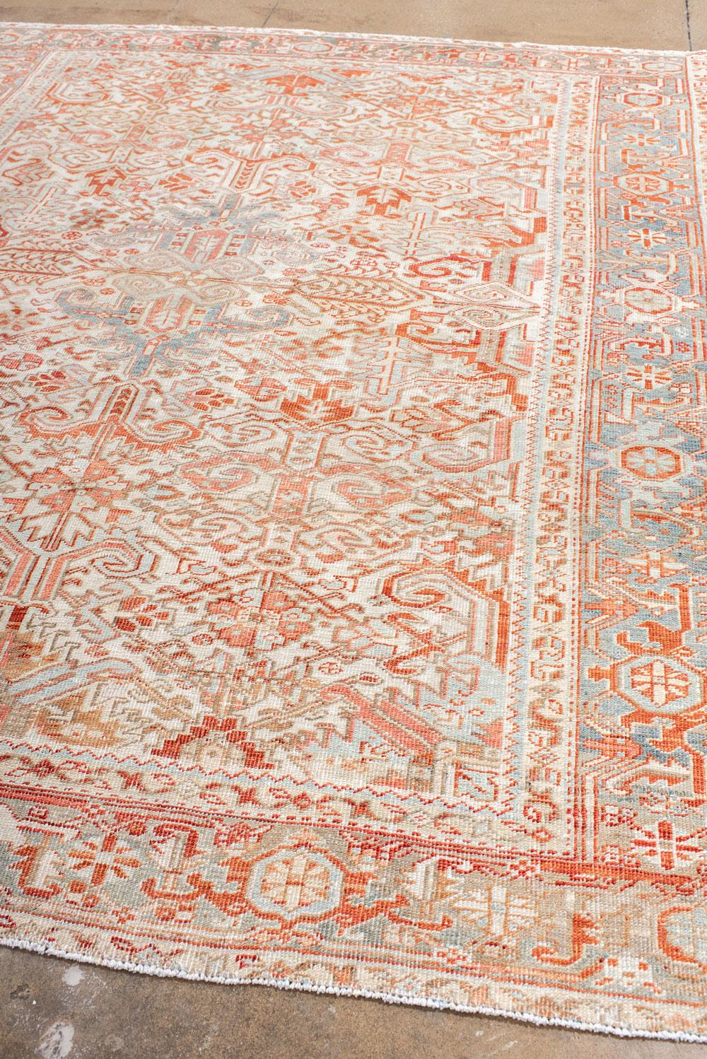 Persian Antique Heriz Carpet Featuring an Array of Rosettes and an Open Medallion For Sale