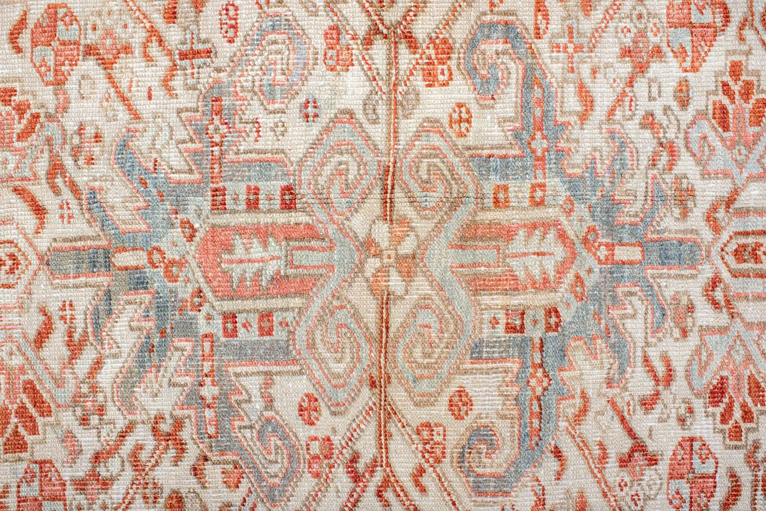 Hand-Knotted Antique Heriz Carpet Featuring an Array of Rosettes and an Open Medallion For Sale