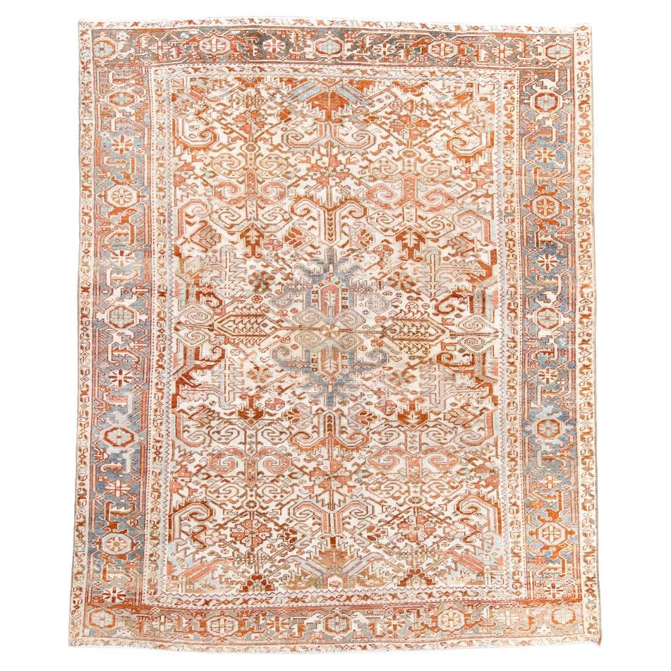 Antique Heriz Carpet Featuring an Array of Rosettes and an Open Medallion For Sale