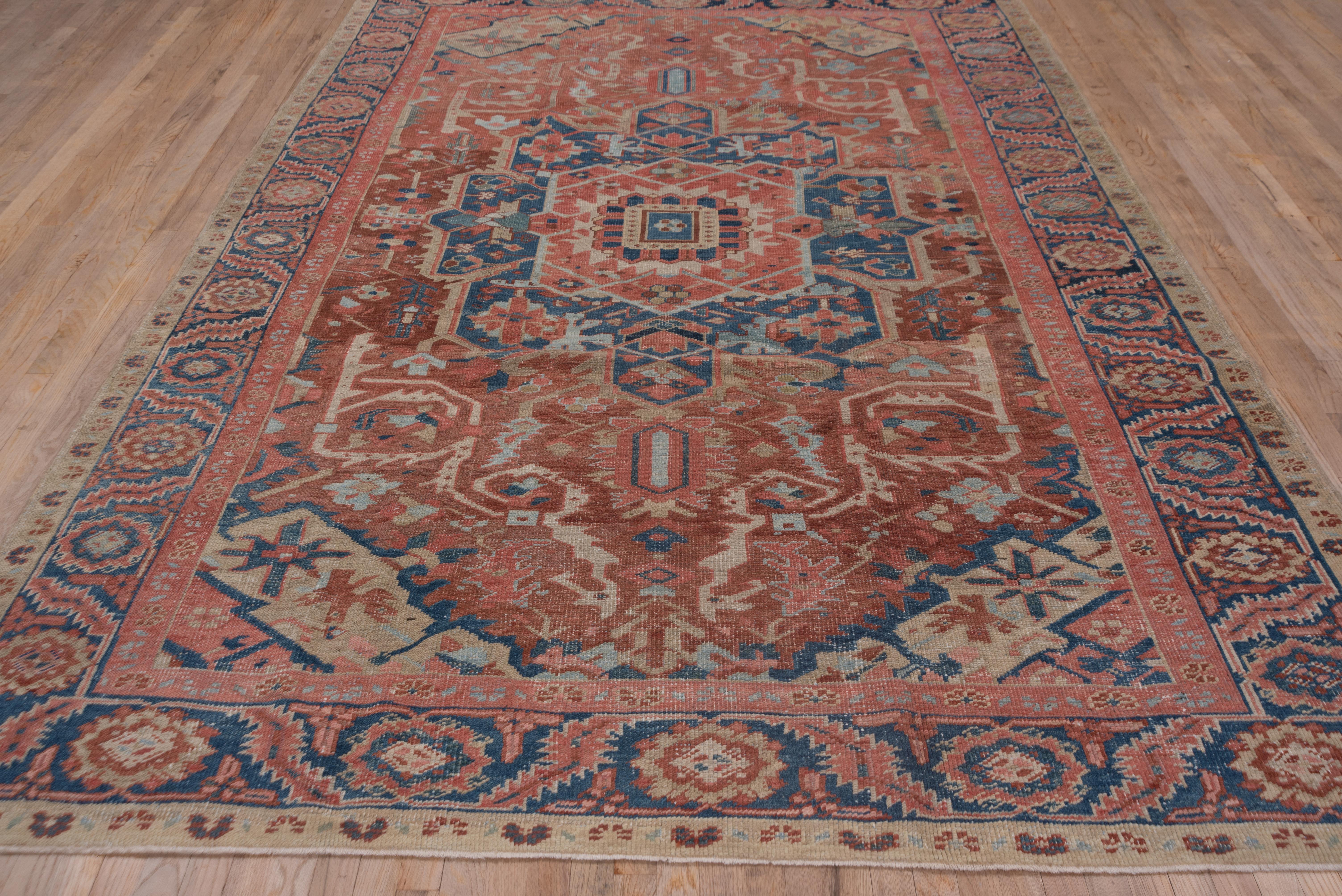 This softly colored NW Persian carpet is of the Gorevan quality, with a coarser weave, watery blue and softer red. The drawing is bold and simple with a light blue octogram medallion and coiling ivory arabesques. The light blue border displays bent