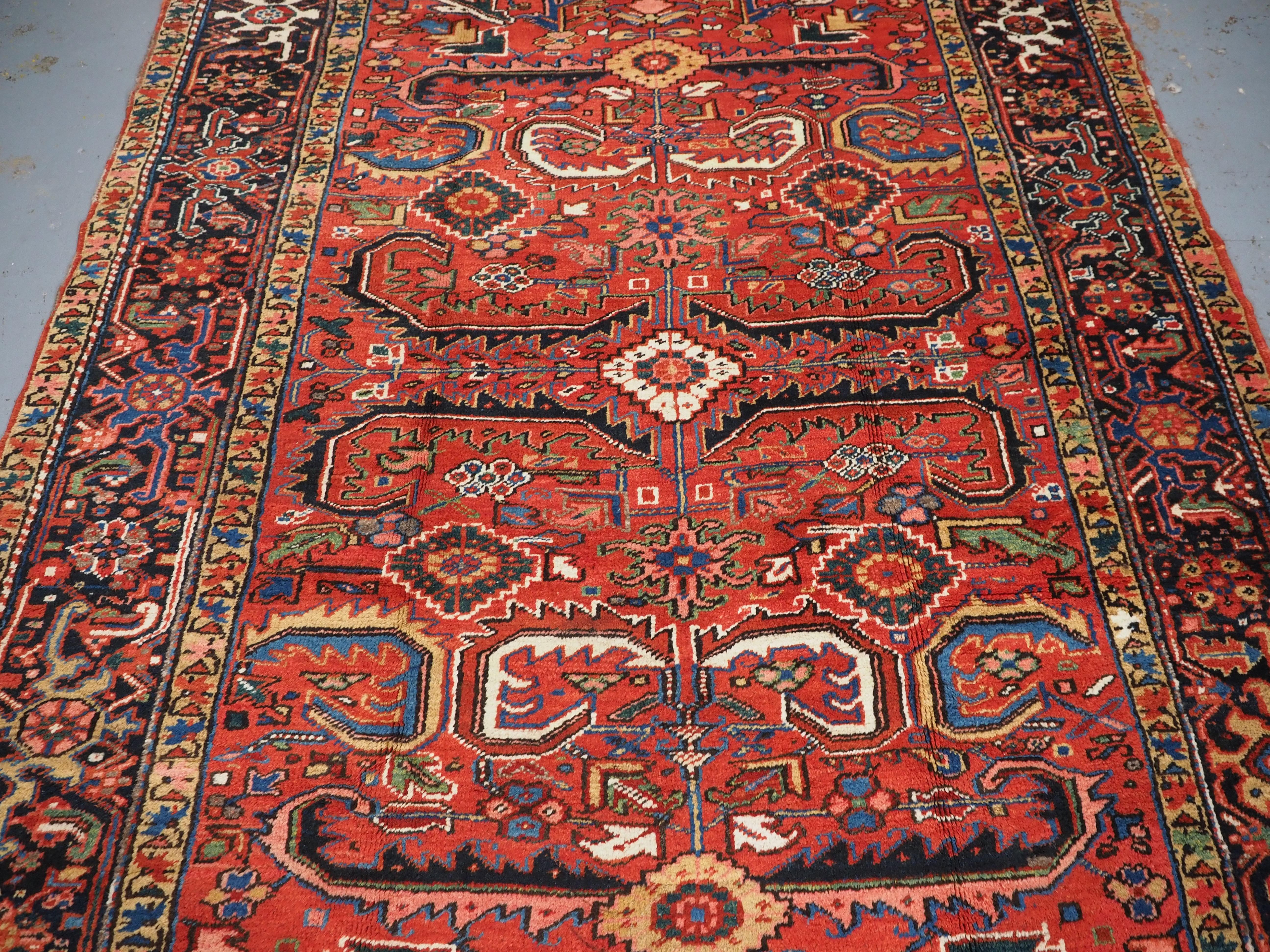 Wool Antique Heriz carpet with a traditional all over design, circa 1910. For Sale