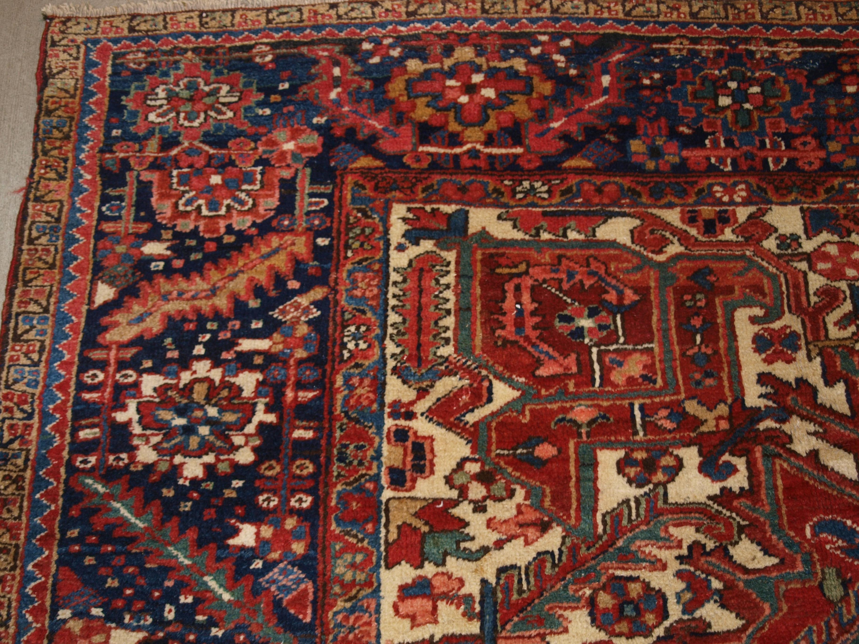 20th Century Antique Heriz Carpet with Large Medallion on Madder Red Field For Sale