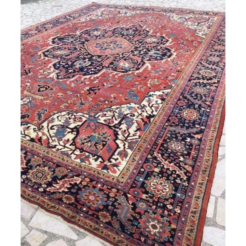 Antique Heriz carpet with a very well-drawn large medallion and excellent clear soft colours. The carpet has a large central medallion of traditional Heriz design, the ground colour is a superb soft madder red with the open design in soft pastel