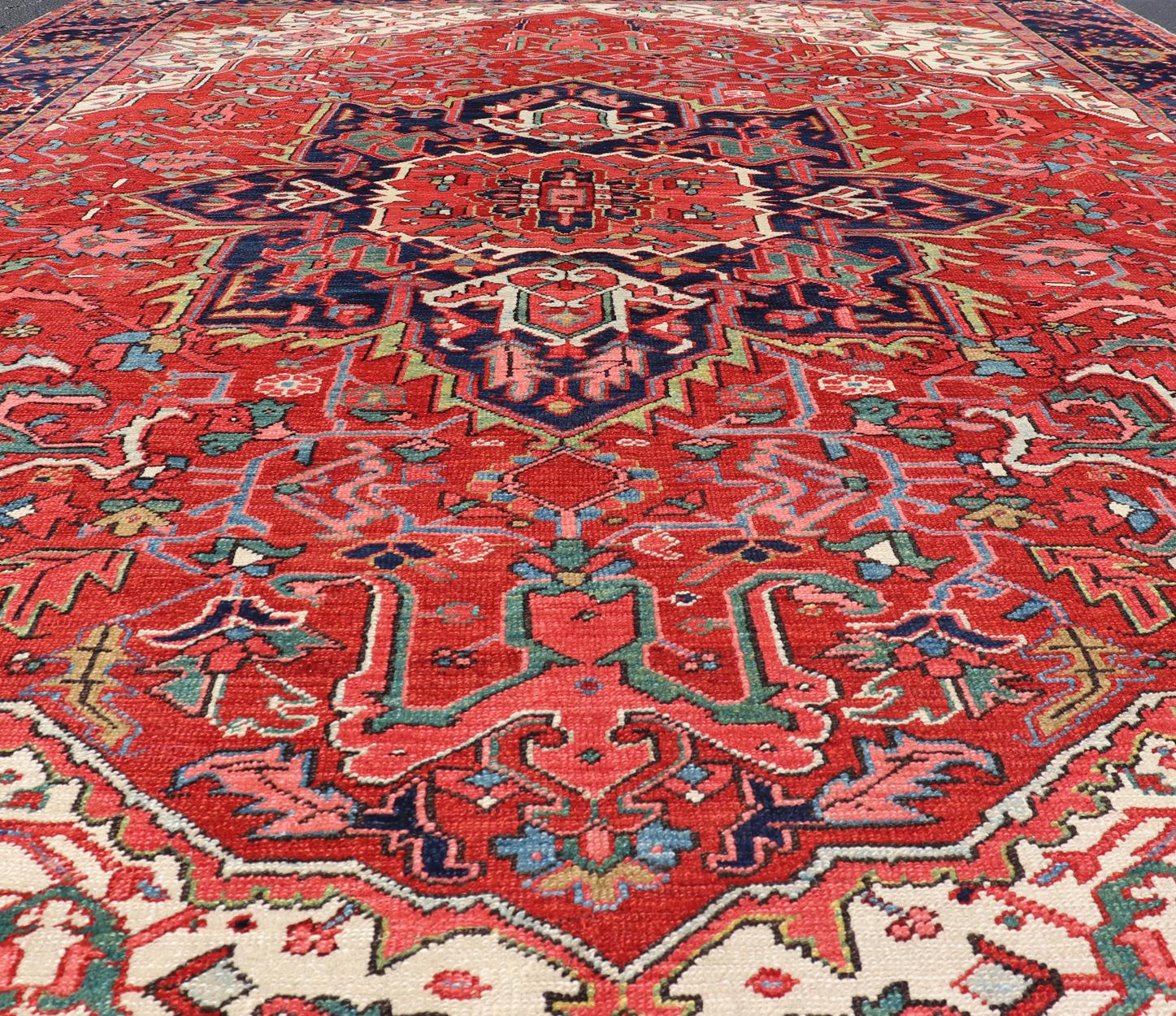 Heriz Serapi Antique Heriz Carpet with Stylized Central Medallion Set on Tomato Red Field For Sale