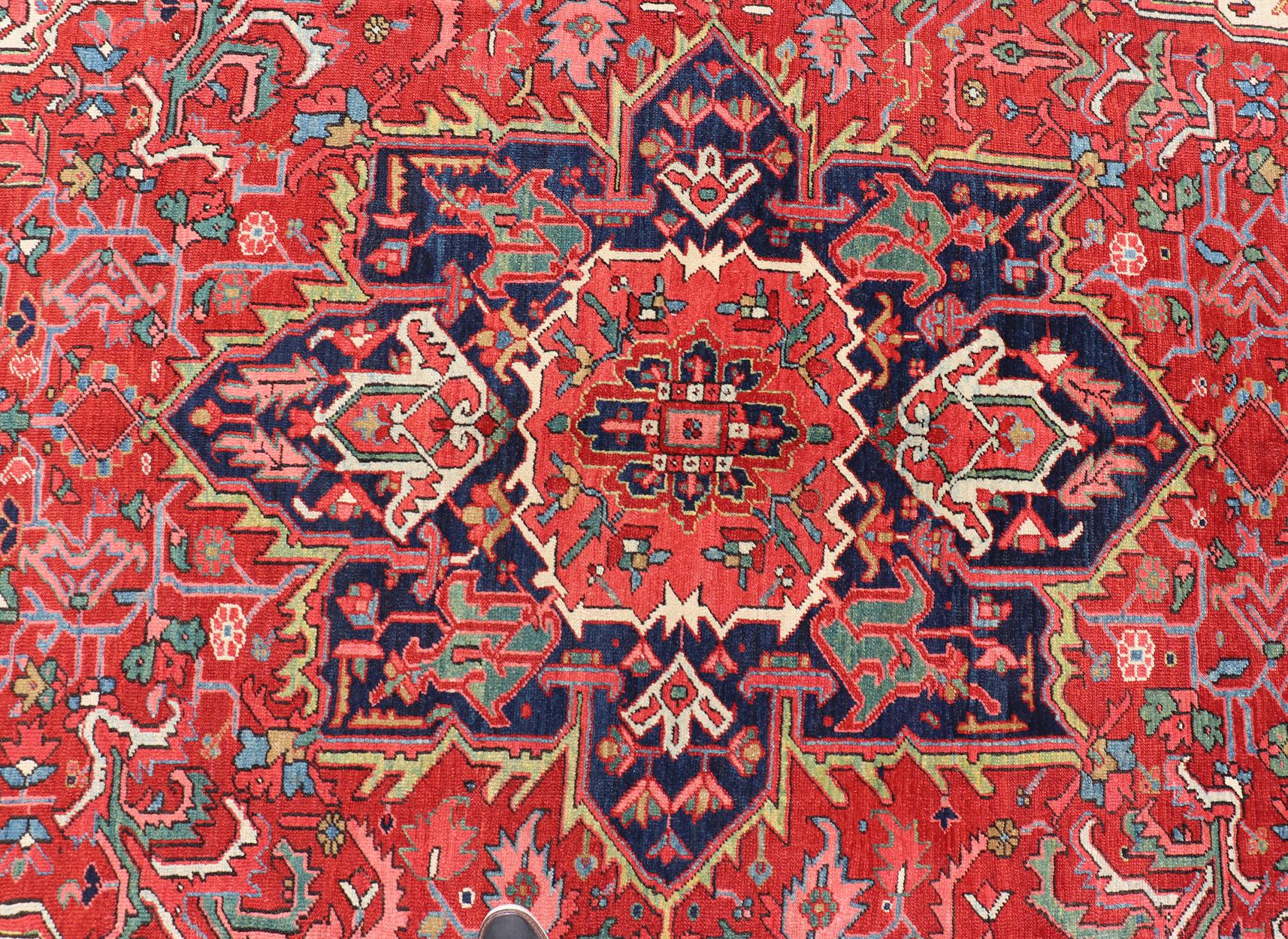 Persian Antique Heriz Carpet with Stylized Central Medallion Set on Tomato Red Field For Sale