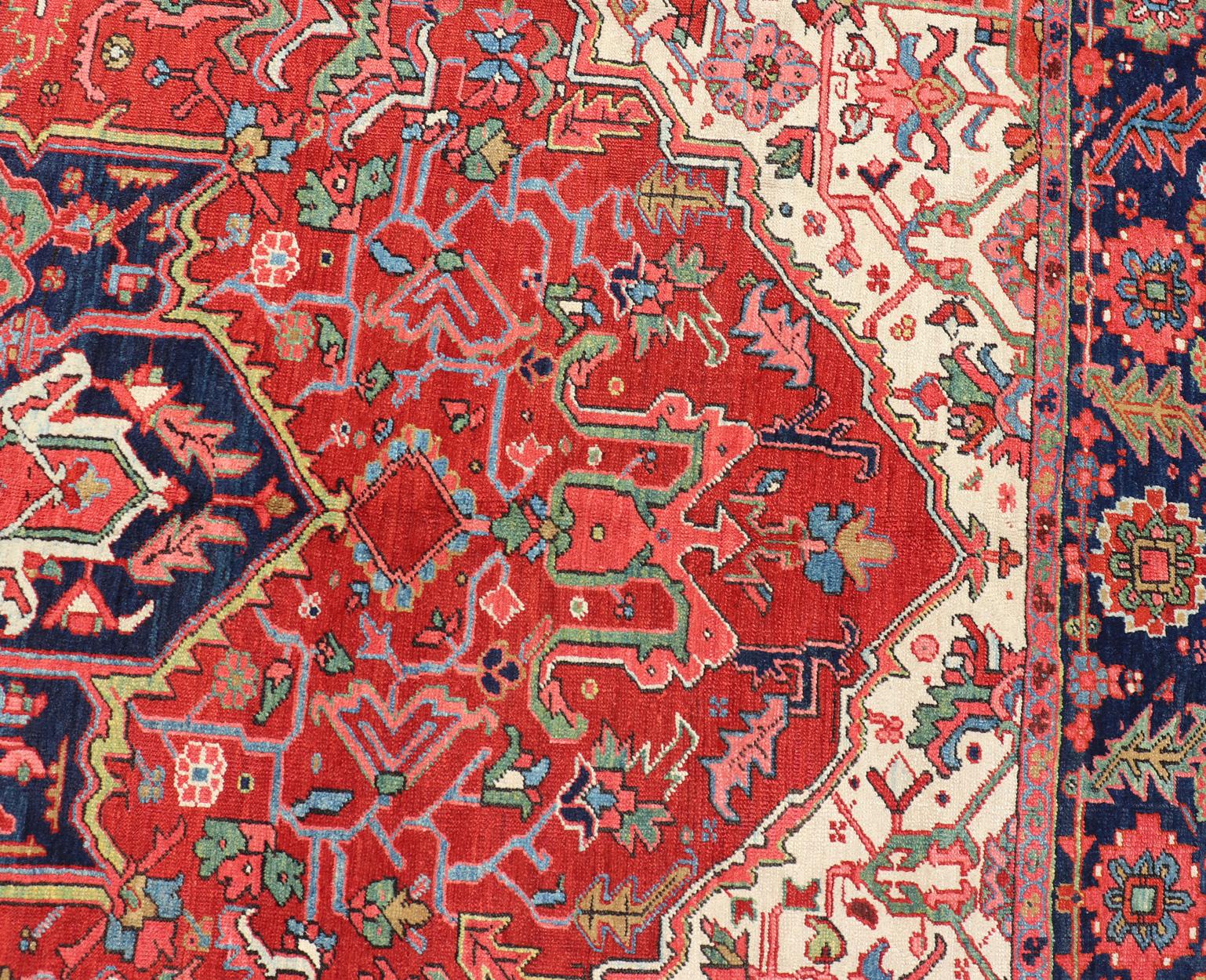 Hand-Knotted Antique Heriz Carpet with Stylized Central Medallion Set on Tomato Red Field For Sale